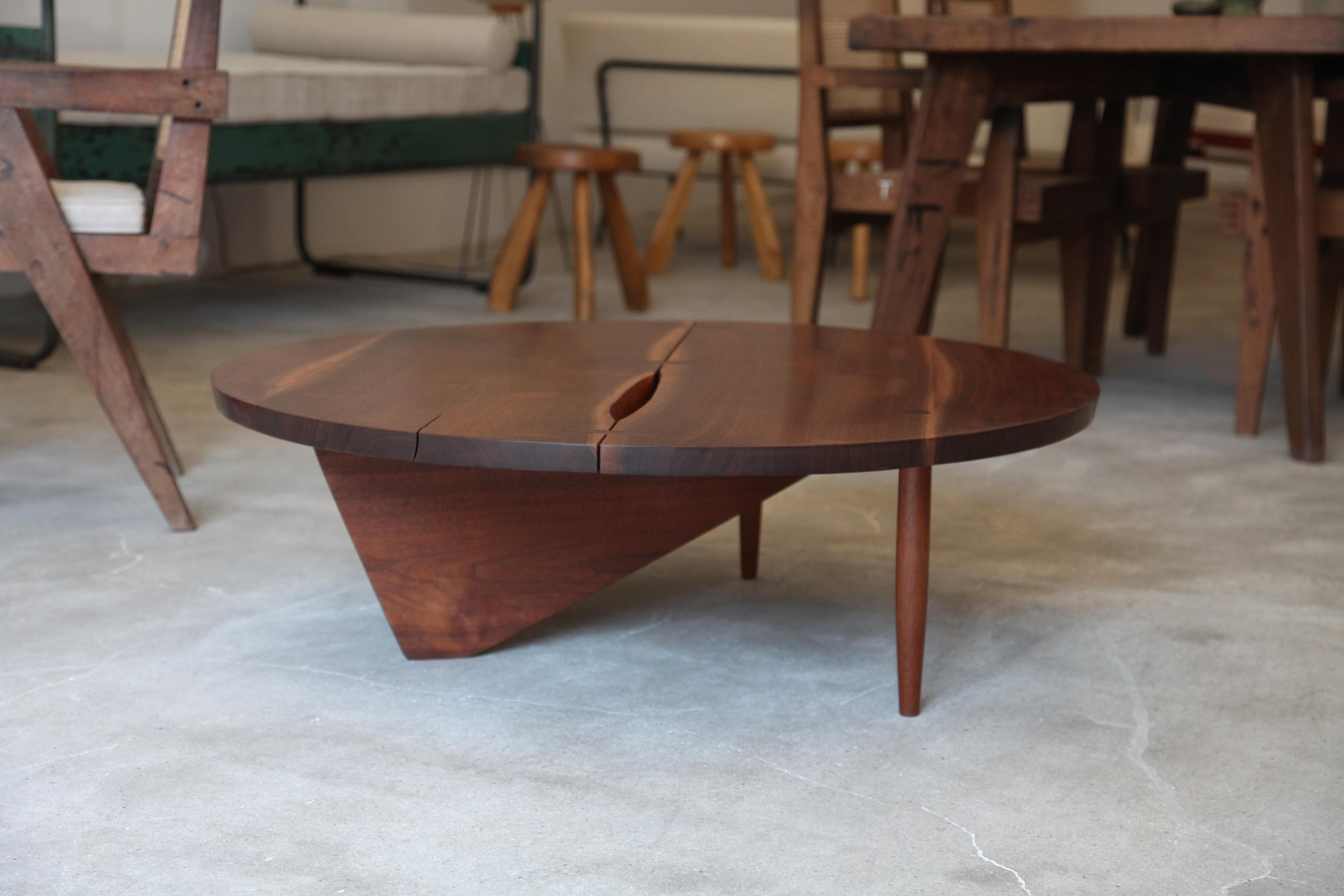 A beautiful walnut coffee table designed by George Nakashima, circa 1960s. Split visible from top is not damage and is contained with a hidden butterfly on the underside (see Image).