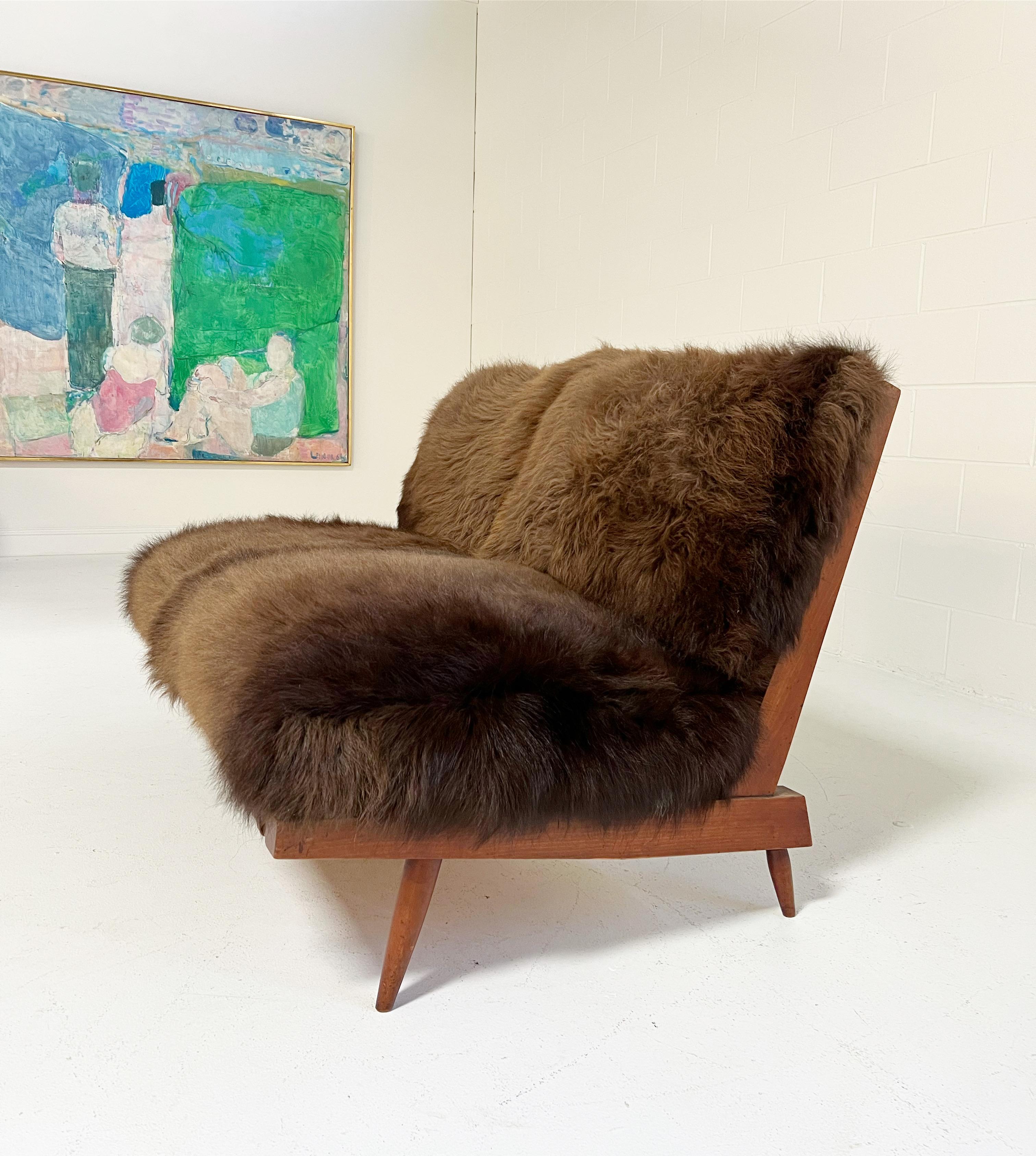 Nakashima's settee is a design lover's dream. Simple wood craftmanship at its finest. The cushions are custom and crafted of thick and soft bison hide. Each is generously filled with feathers for a most comfortable seat. We love how the chocolate