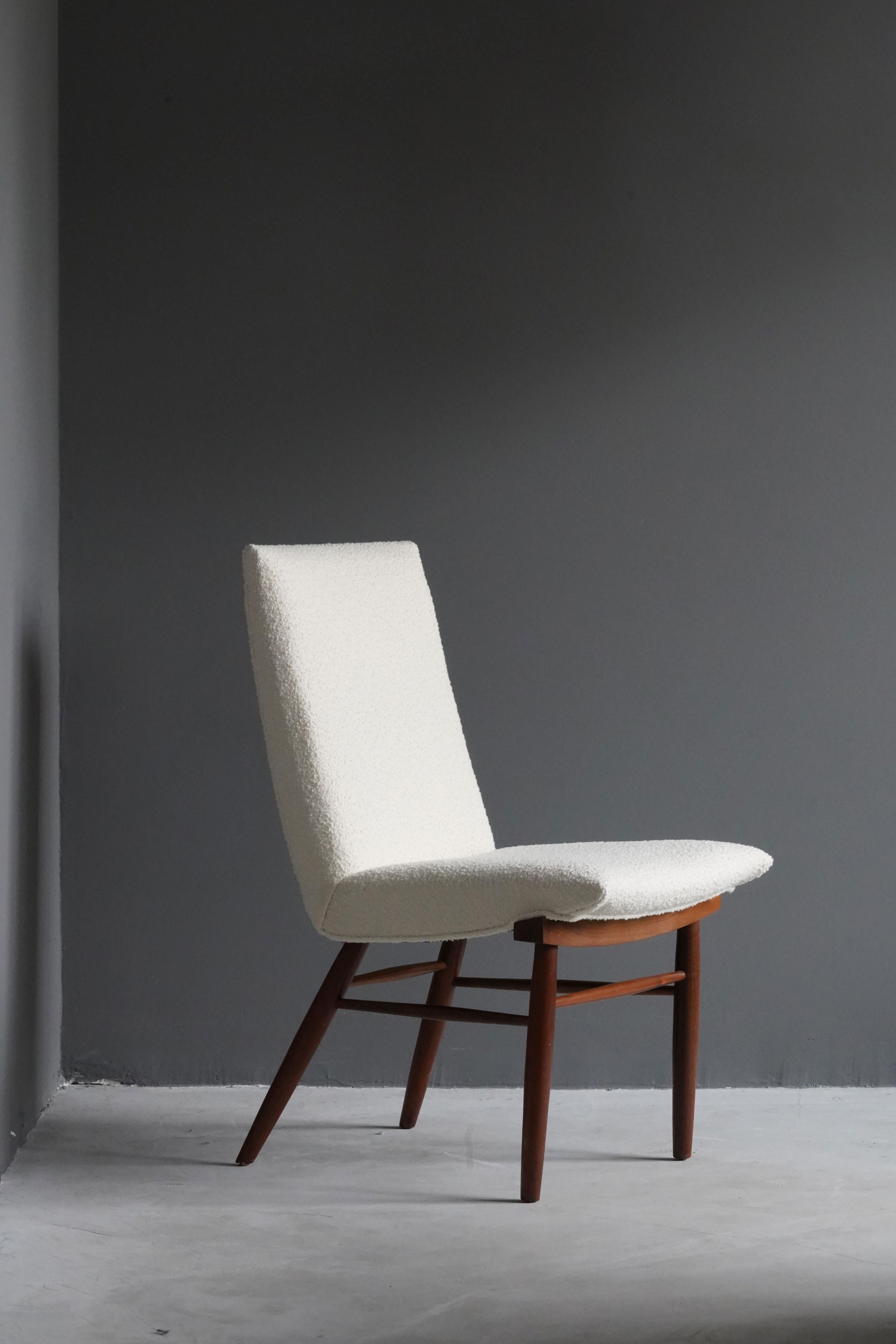 A side chair, designed by George Nakashima, produced by Widdicomb Furniture Company, Grand Rapids, Michigan, America, 1960s.

Features finely turned walnut, overstuffed seat reupholstered in Knoll Bouclé fabric.