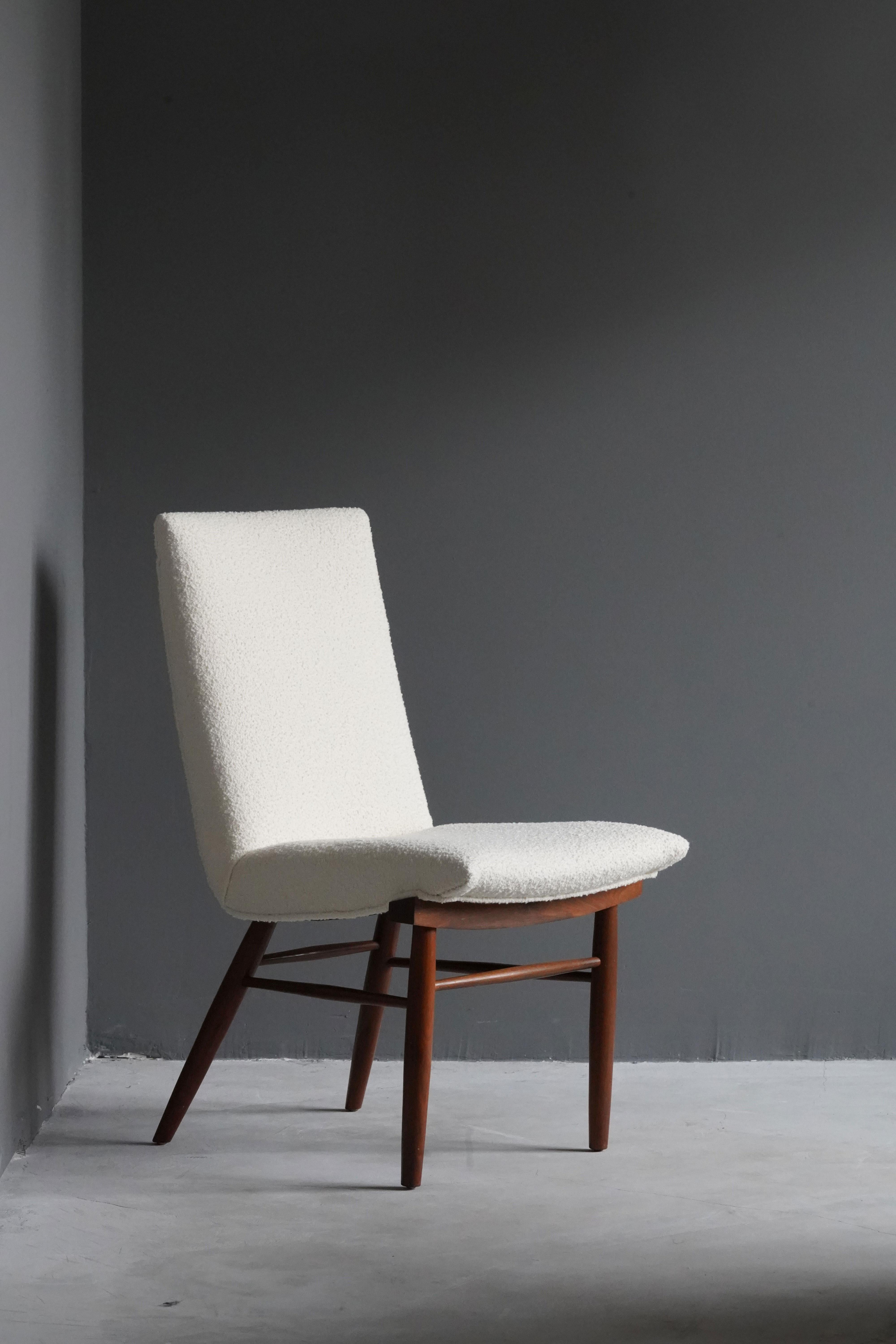 A side chair, designed by George Nakashima, produced by Widdicomb Furniture Company, Grand Rapids, Michigan, America, 1960s.

Features finely turned walnut, overstuffed seat reupholstered in Knoll Bouclé fabric.