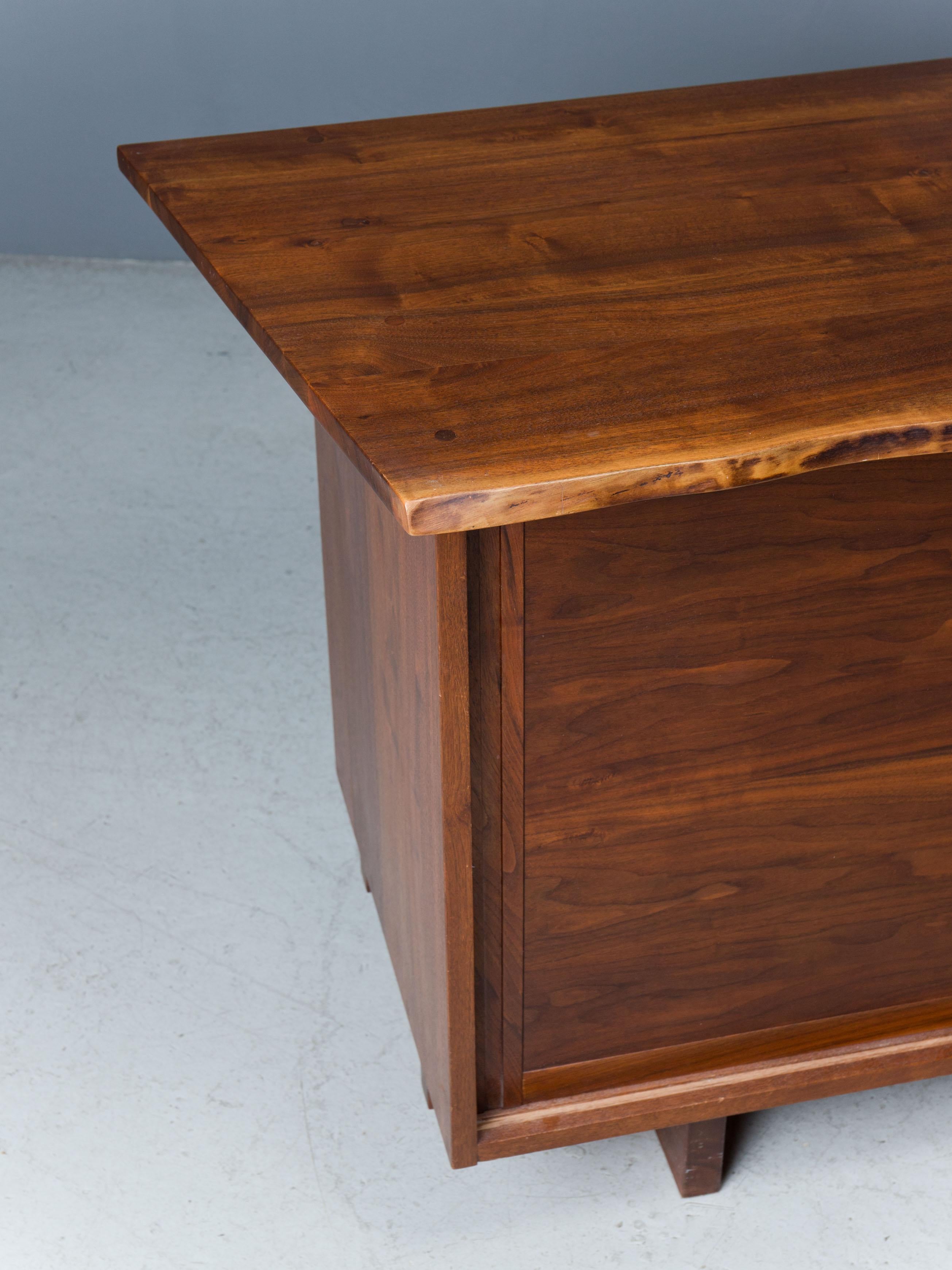 Cabinet features expressive American black walnut top with overhang
and free edge, two sliding doors concealing eight drawers.

Sold with a digital copy of the original order card.