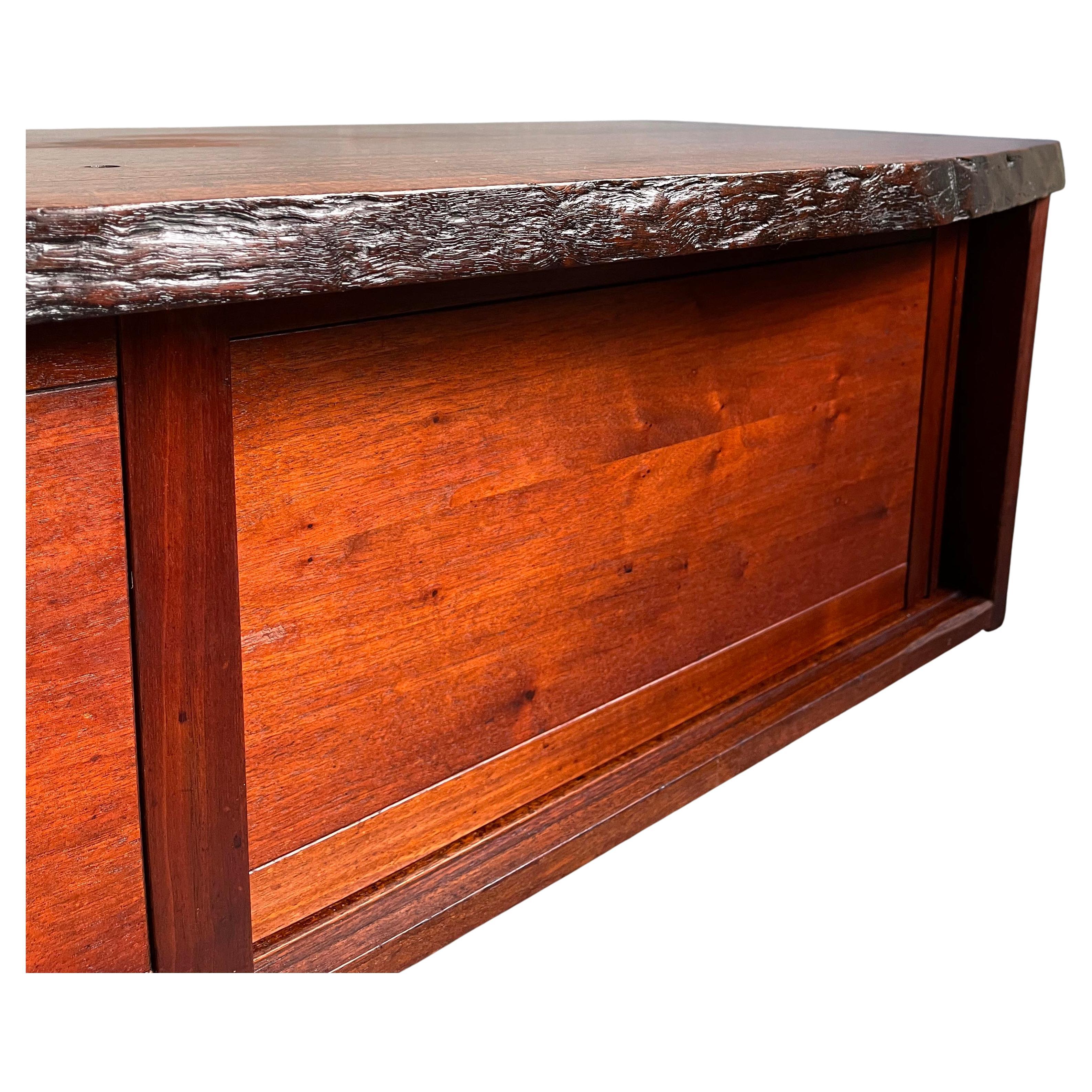 Gorgeous George Nakashima cabinet features a single slab laurel top with one free edge above two doors concealing two adjustable shelves. Perfect low cabinet also could be a wonderful coffee table. Sold with a digital copy of the original order