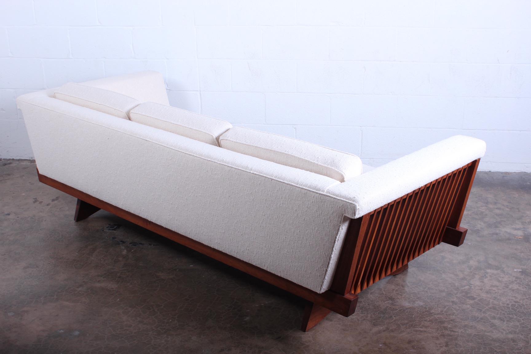 A rare sofa designed by George Nakashima for Widdicomb. Newly upholstered in Holly Hunt fabric.