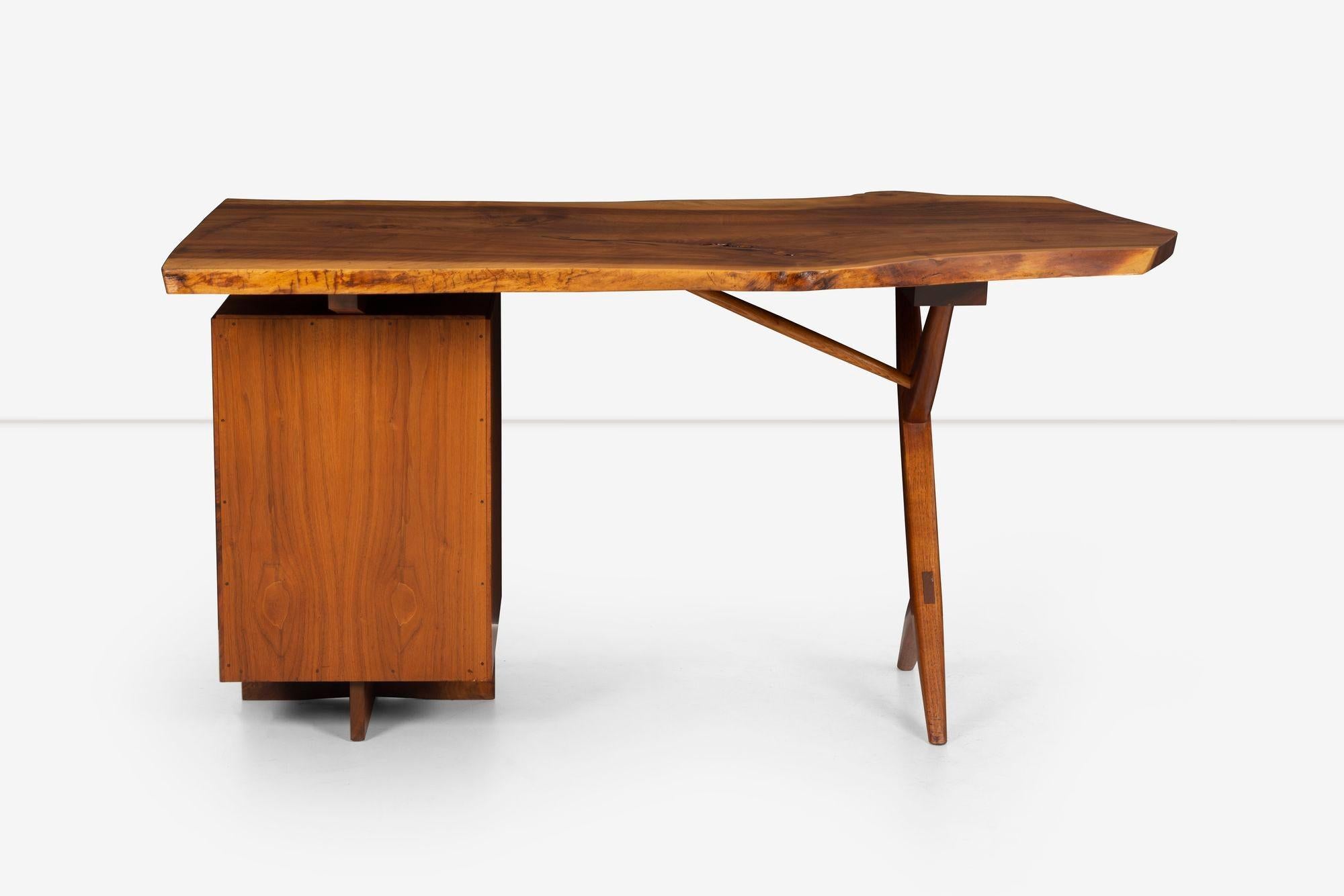 George Nakashima Special Conoid Desk with Two Free Edges Top in intense-grained English Walnut, Selected by George with walnut cross-leg support and a three-drawer pedestal storage base.
It comes with a copy of the drawing of the desk by George