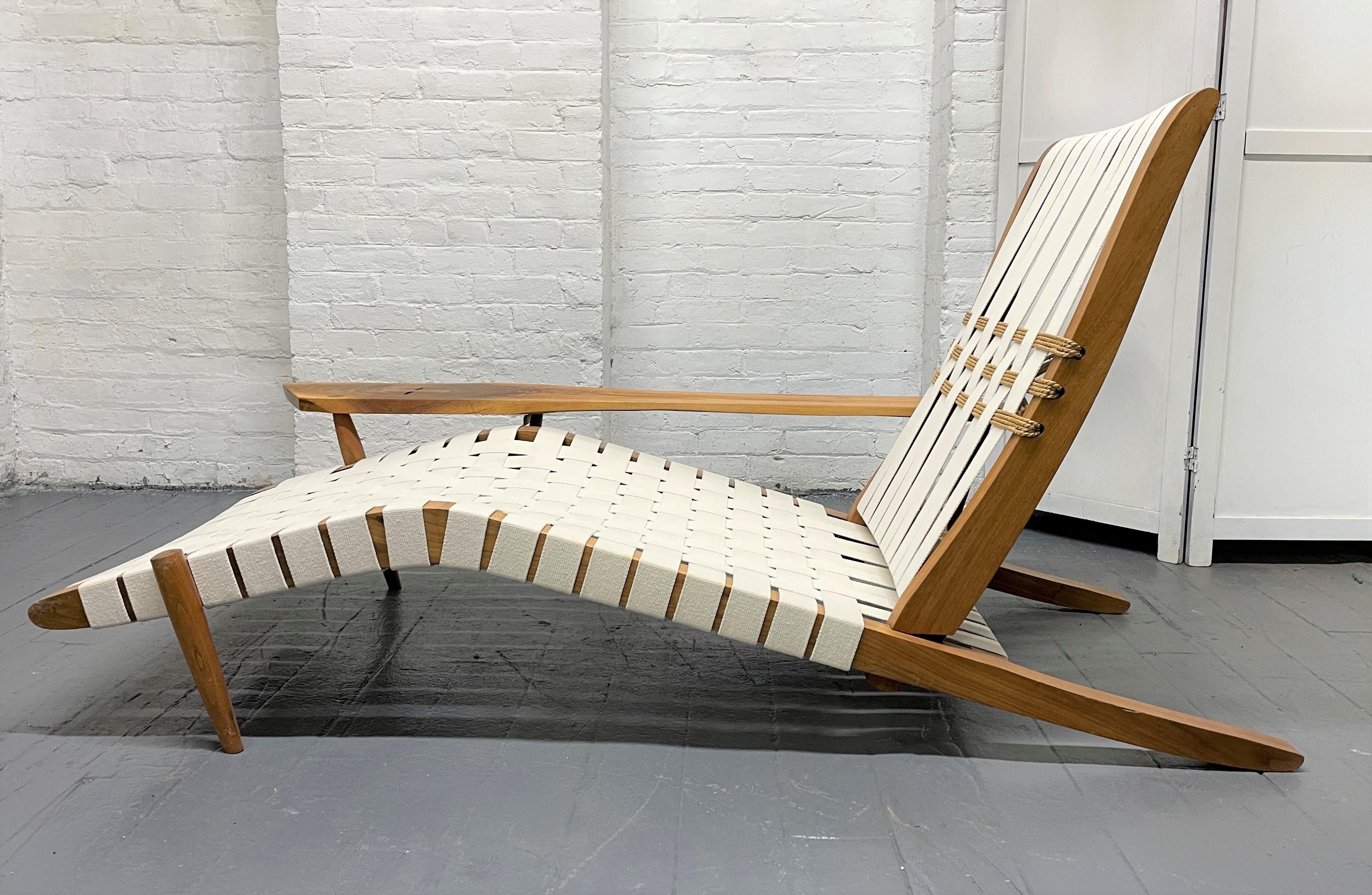 George Nakashima Studio chaise lounge long chair with free-form arm. The chair is walnut with sea grass details and woven webbing. Sold with a certificate of authenticity.