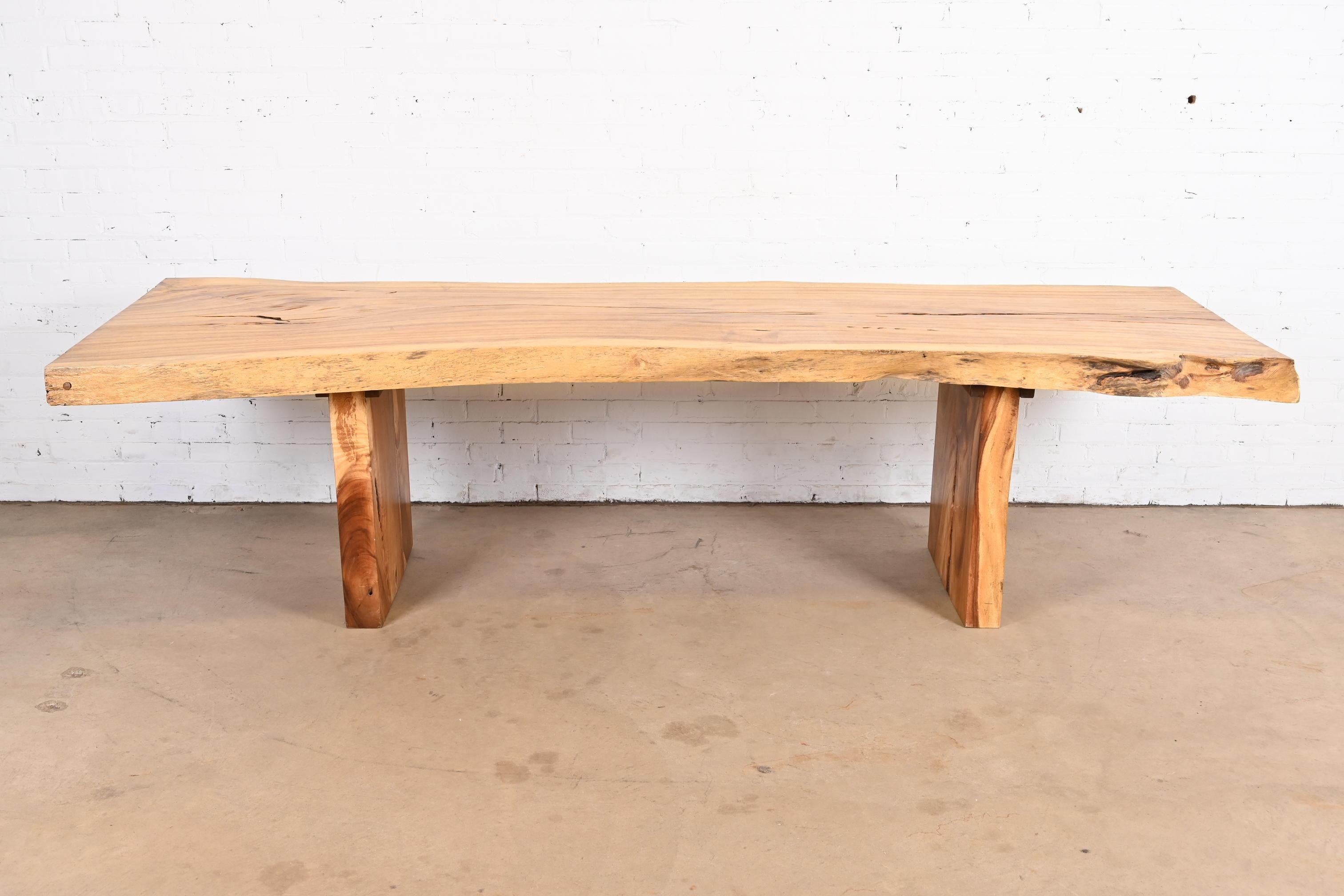 An exceptional Organic Modern dining table

USA, 20th Century

Solid walnut slab top and legs, with live edges.

Measures: 112.25