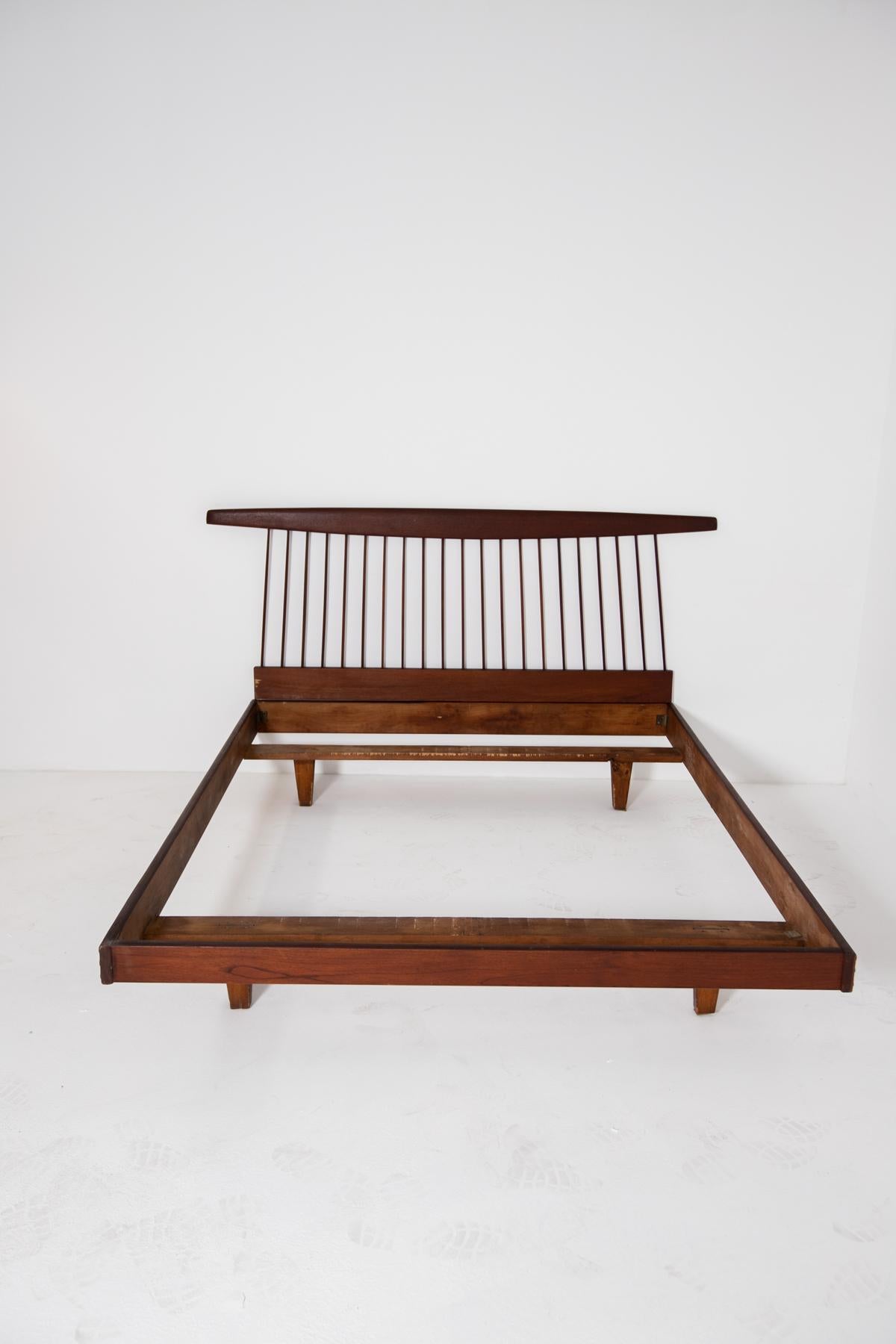 George Nakashima's walnut bedroom bed or futon from the 1950s. The bed is made entirely of walnut and is a marvellous work of essential design with clean, rigorous lines. The bed is made of wooden sheets assembled together with wooden bolts. Its