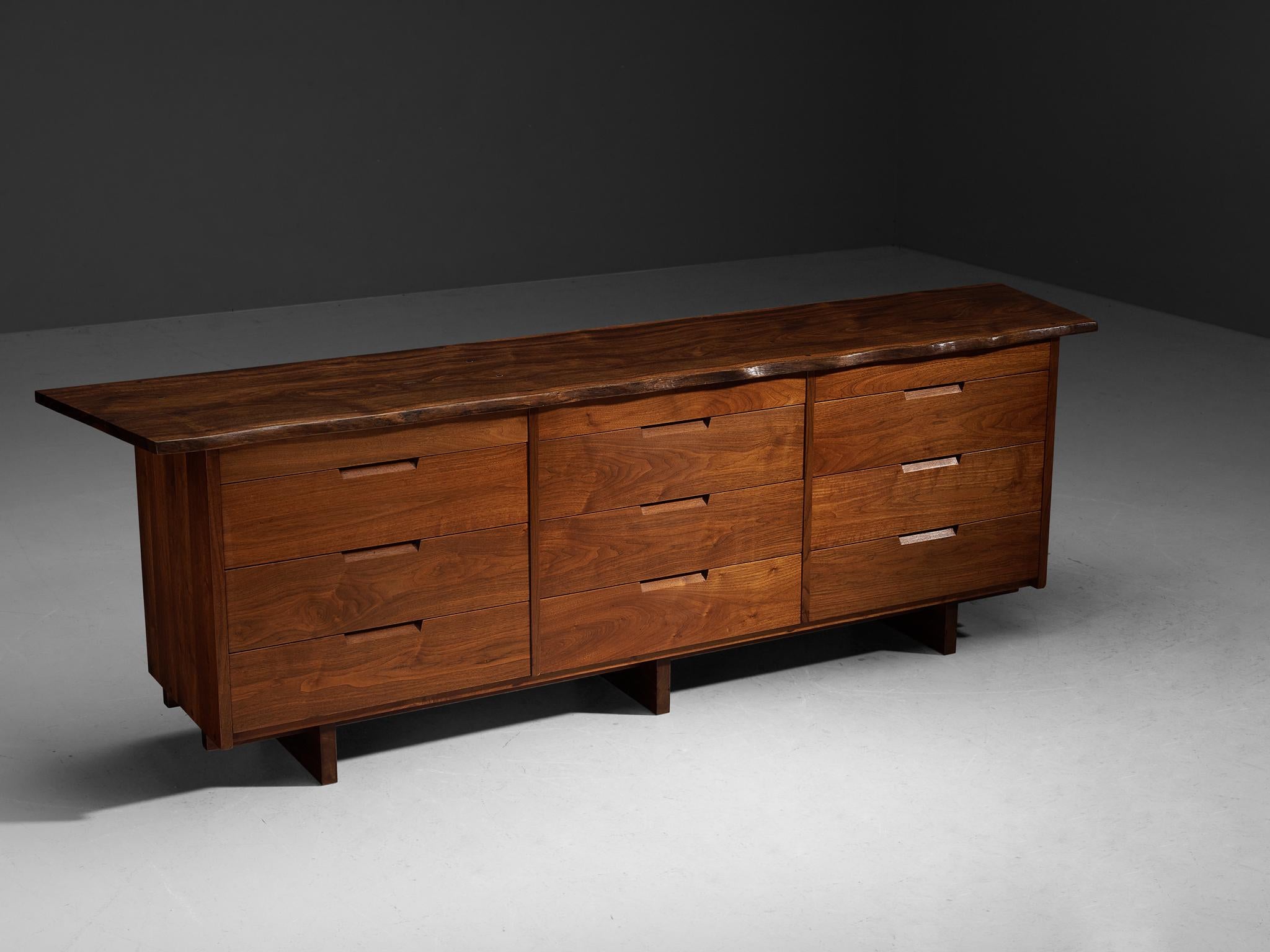 George Nakashima, triple chest of drawers or sideboard, American black walnut, Indian laurel, United States, 1964

With regard to its essential form, material use, and woodwork, this chest of drawers is a testimony to George Nakashima's expert