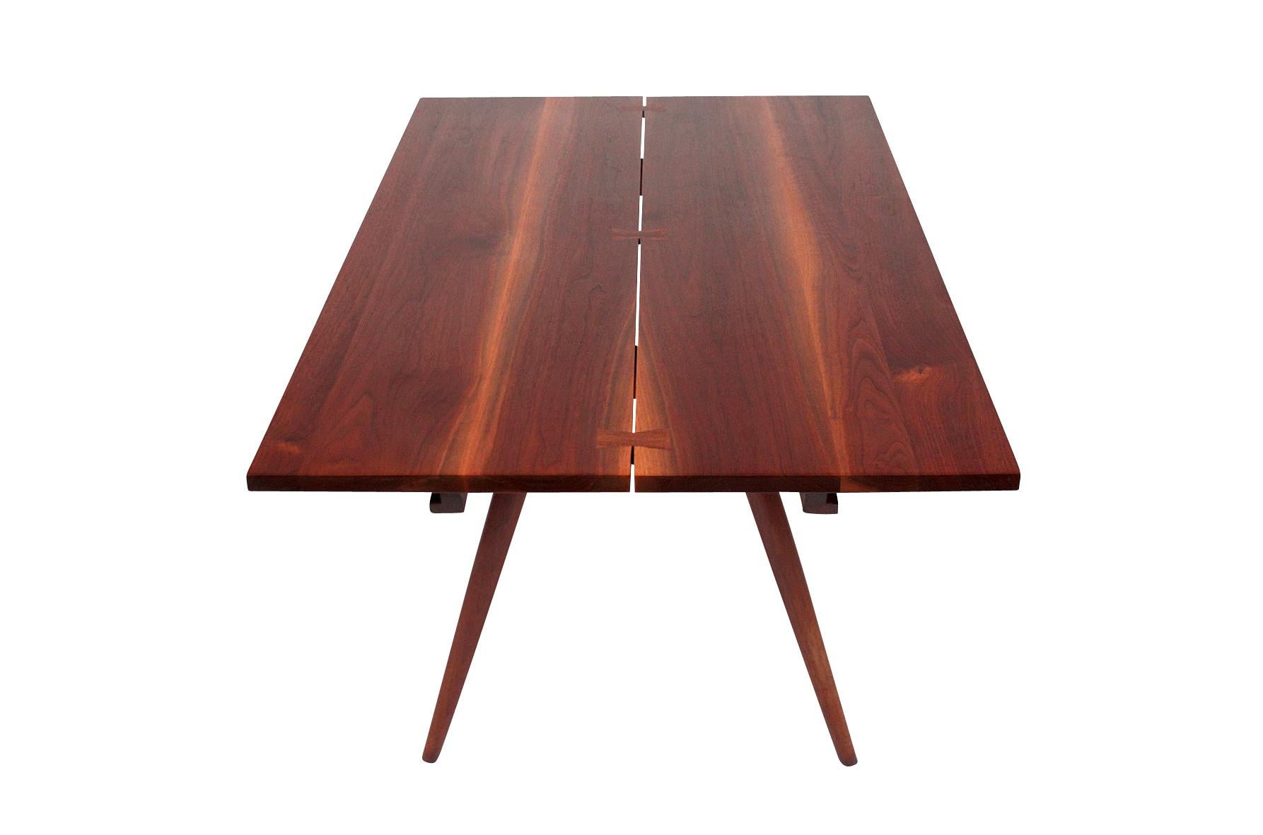 George Nakashima dining table with three rosewood butterflies and two extensions. Book-matched top with distinctive sap grain. Signed with clients name to bottom. Table has been completely refinished.
Measures: Each leaf 16