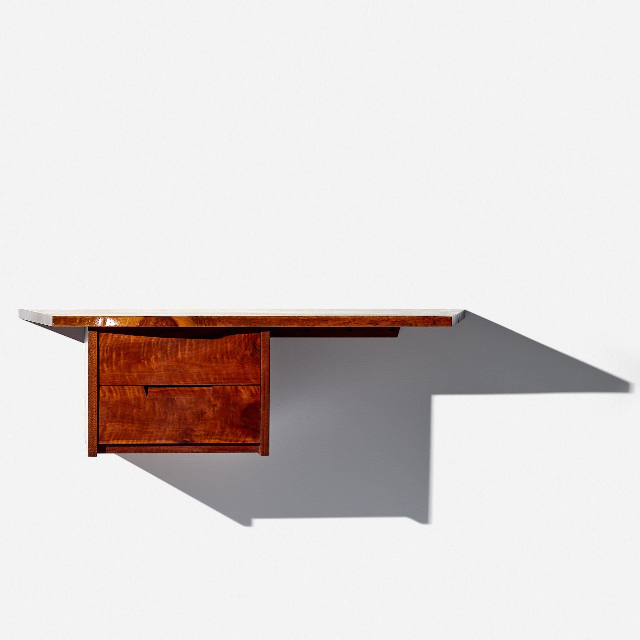 George Nakashima
Hanging wall mount desk
Nakashima Studio,
circa 1960s
American black walnut
Measures: 42 W × 20 D × 13 H inches

Highly figured overhanging top. Highly figured drawer fronts.

Sold with the original drawing.