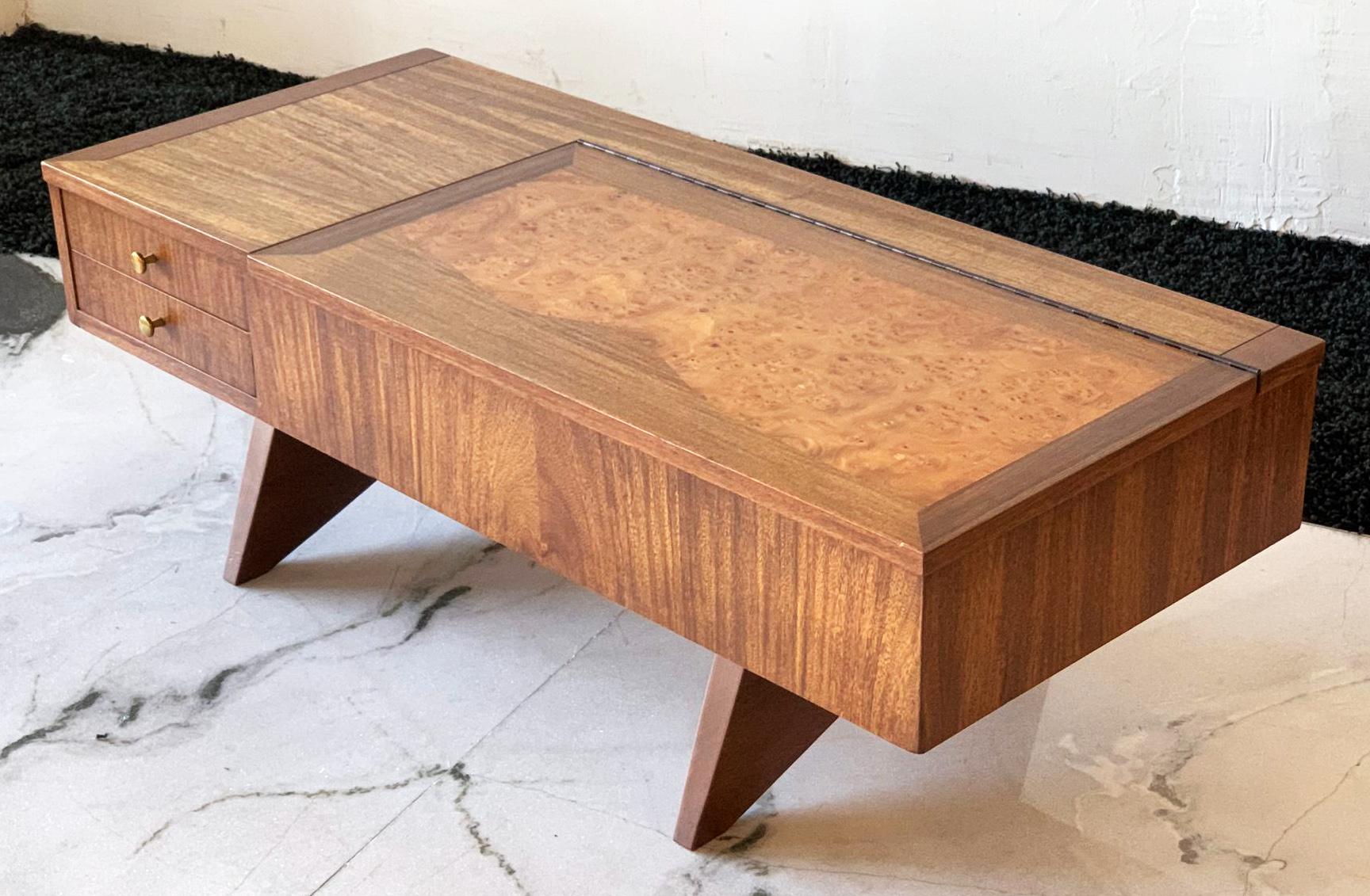 This coffee table is truly stunning; a George Nakashima for Widdicomb Origins collection walnut coffee table with the rare burl inlay. This coffee table has all the staples of a fine George Nakashima piece, splayed legs, walnut cross beam on the