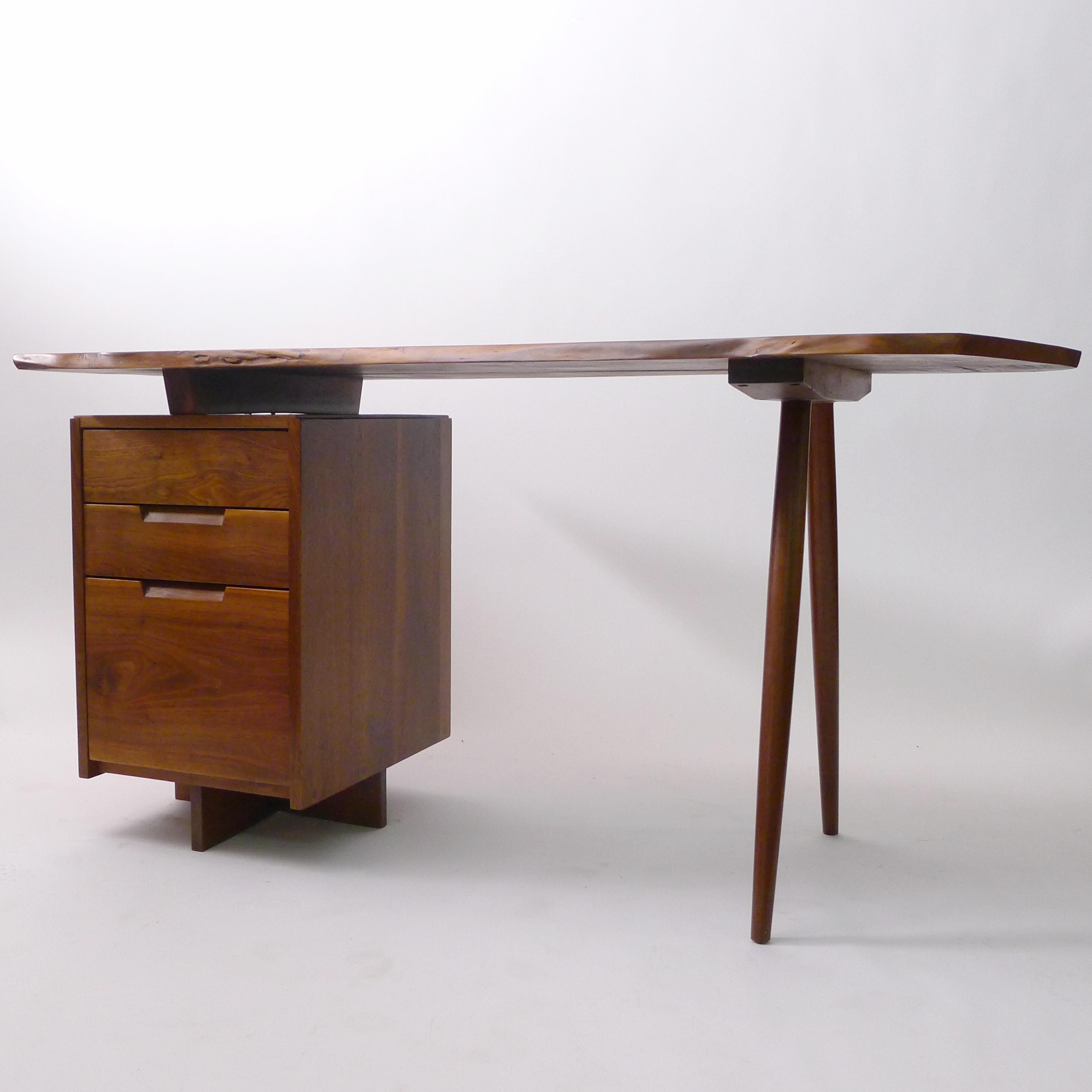 George Nakashima (1905-1990)
Walnut Desk, 1972
with pedestal of one deep and two shallow drawers, raised on cross foot, to the left side and two turned legs to the right side
free edge to front and shaped right end
Nakashima Studio, New Hope,