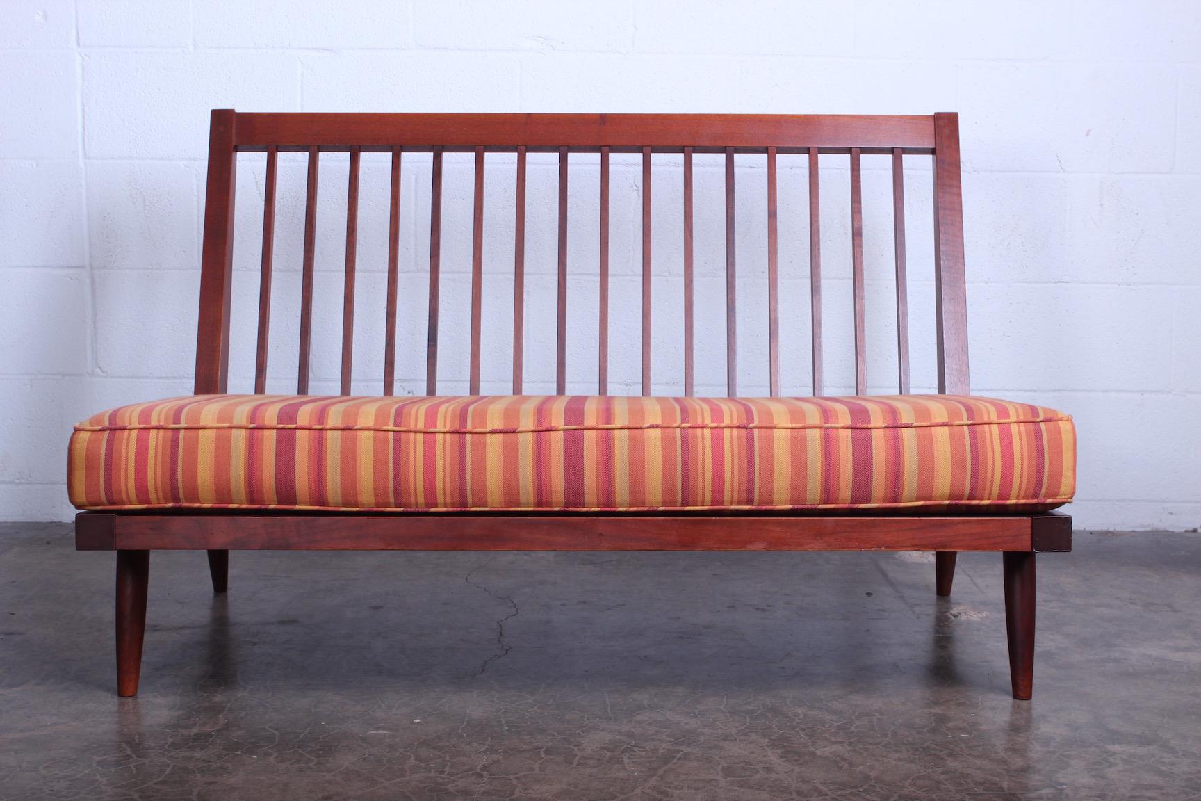 A walnut settee by George Nakashima, 1961. Sold with a copy of the original receipt.