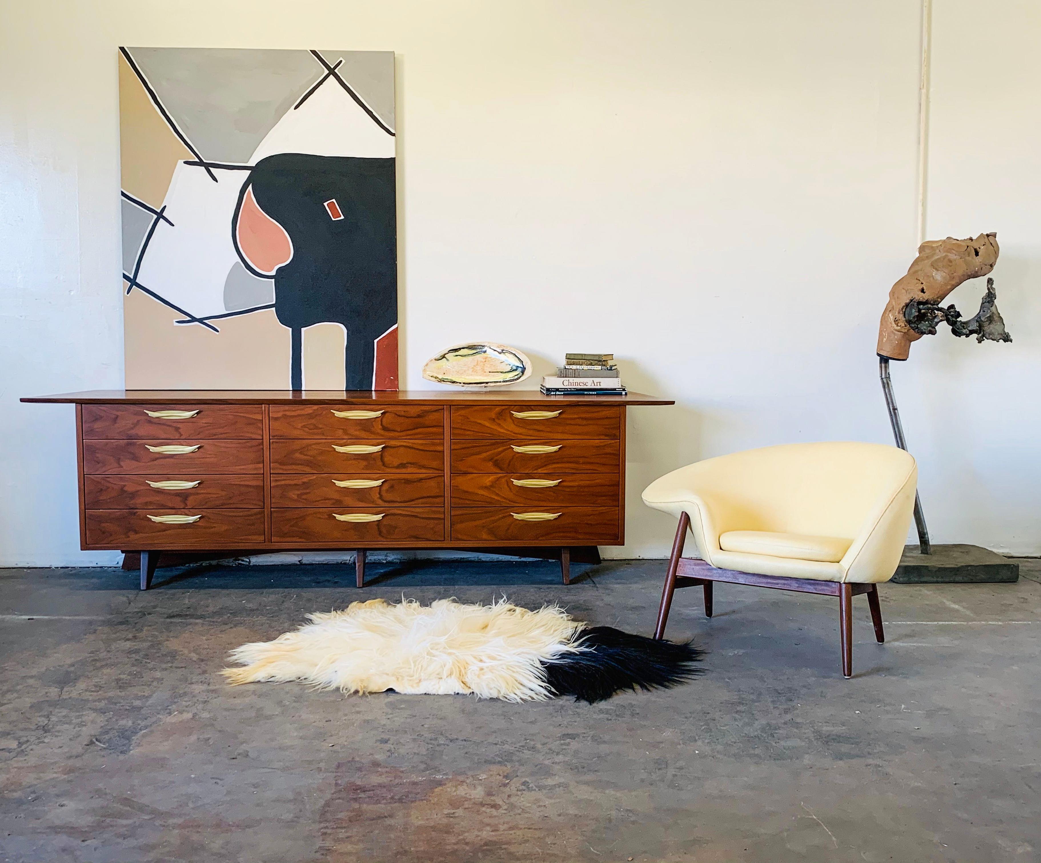 This credenza is absolutely beautiful. This specific example of George Nakashima's work features book-matched walnut throughout, impeccable grain, visible dowels on the top and gorgeous splayed legs.

This credenza / dresser is available to view at