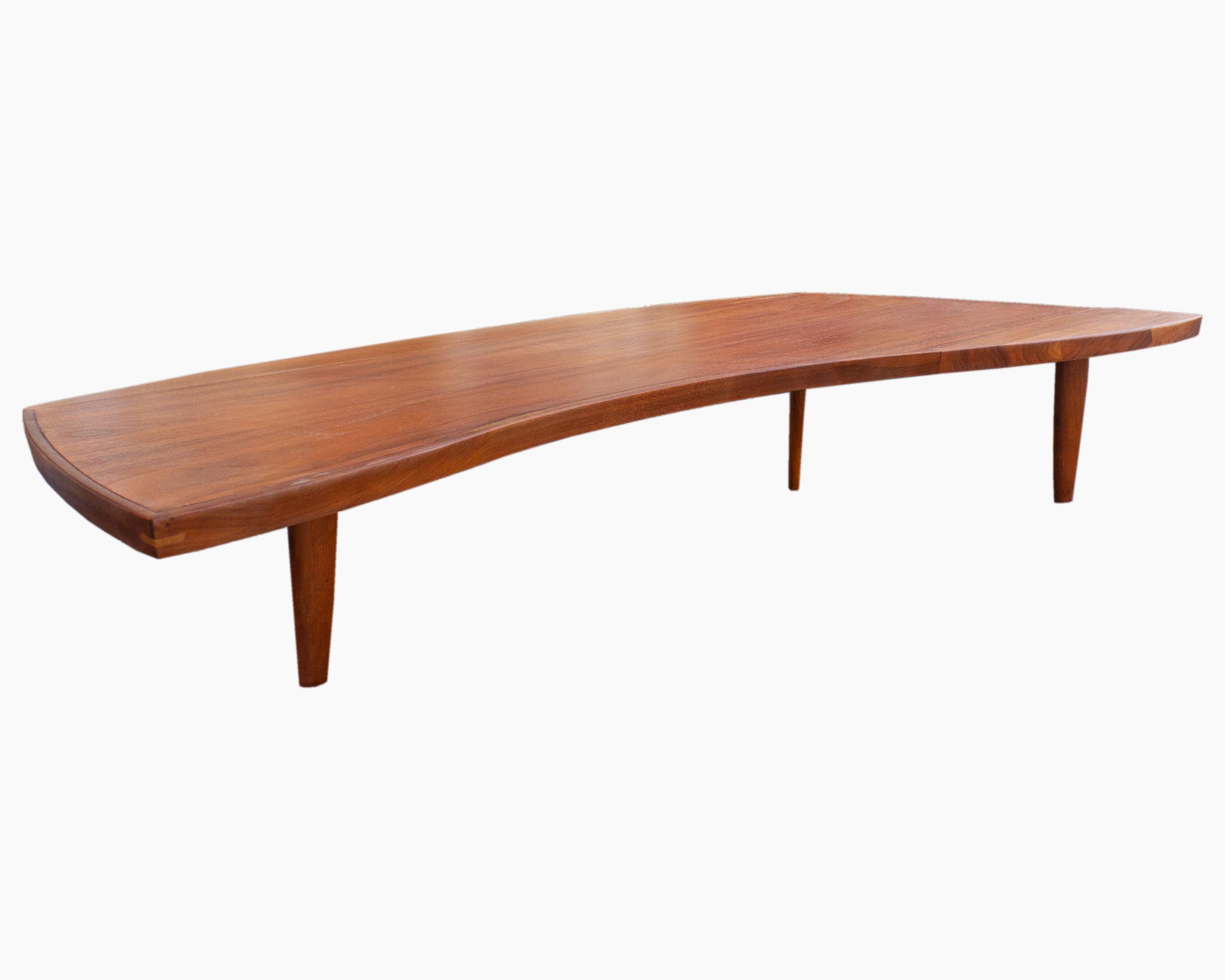 A Mid Century Modern Sundra coffee table designed by Japanese-American architect, woodworker, and furniture maker George Nakashima (1905-1990) for Widdicomb Furniture Company of Grand Rapids, Michigan. Composed of walnut, the elongated and low-set