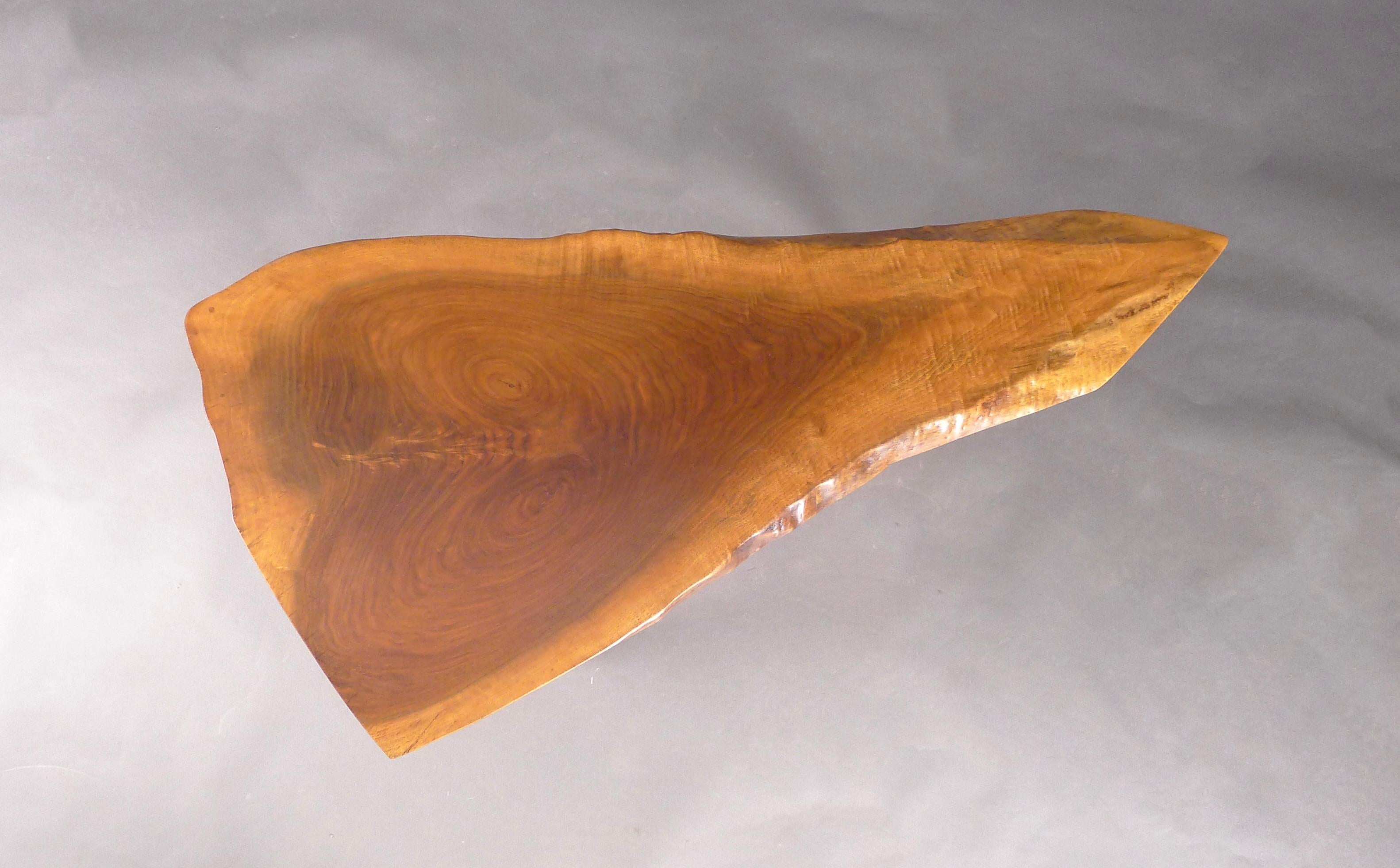 George Nakashima (1905-1990)
Wohl Occasional or End Table
Nakashima Studio, USA 1977
American black walnut single slab top with free or 'live' edges, expressive grain and sapwood details, on three turned tapering legs

102cm wide, 50cm deep, 53cm