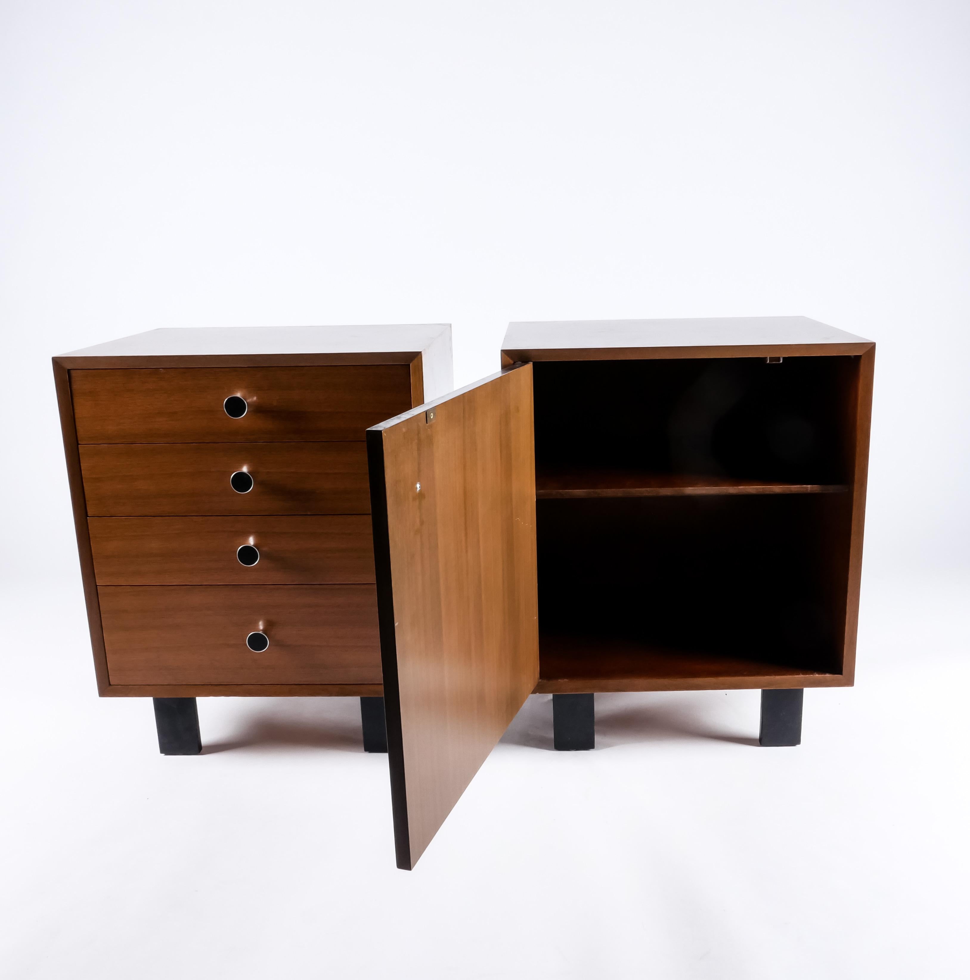 A fantastic pair of cabinets by George Nelson from his “Basic Cabinet Series” 1946. These retain their original finish in excellent condition, and have the less common round enameled pulls. One has four drawers while the other a single cabinet door