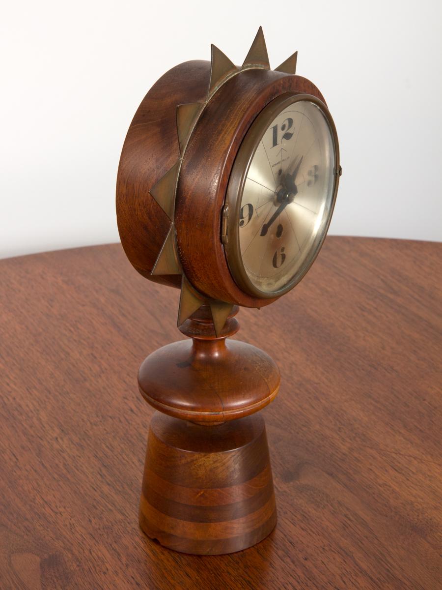 Rare model #2251 chess piece table clock designed by George Nelson for Howard Miller Clock Company. Turned walnut base supports wooden case that is decorated with a crown of brass points. Reflective face indicates the hour in a distinctly modern