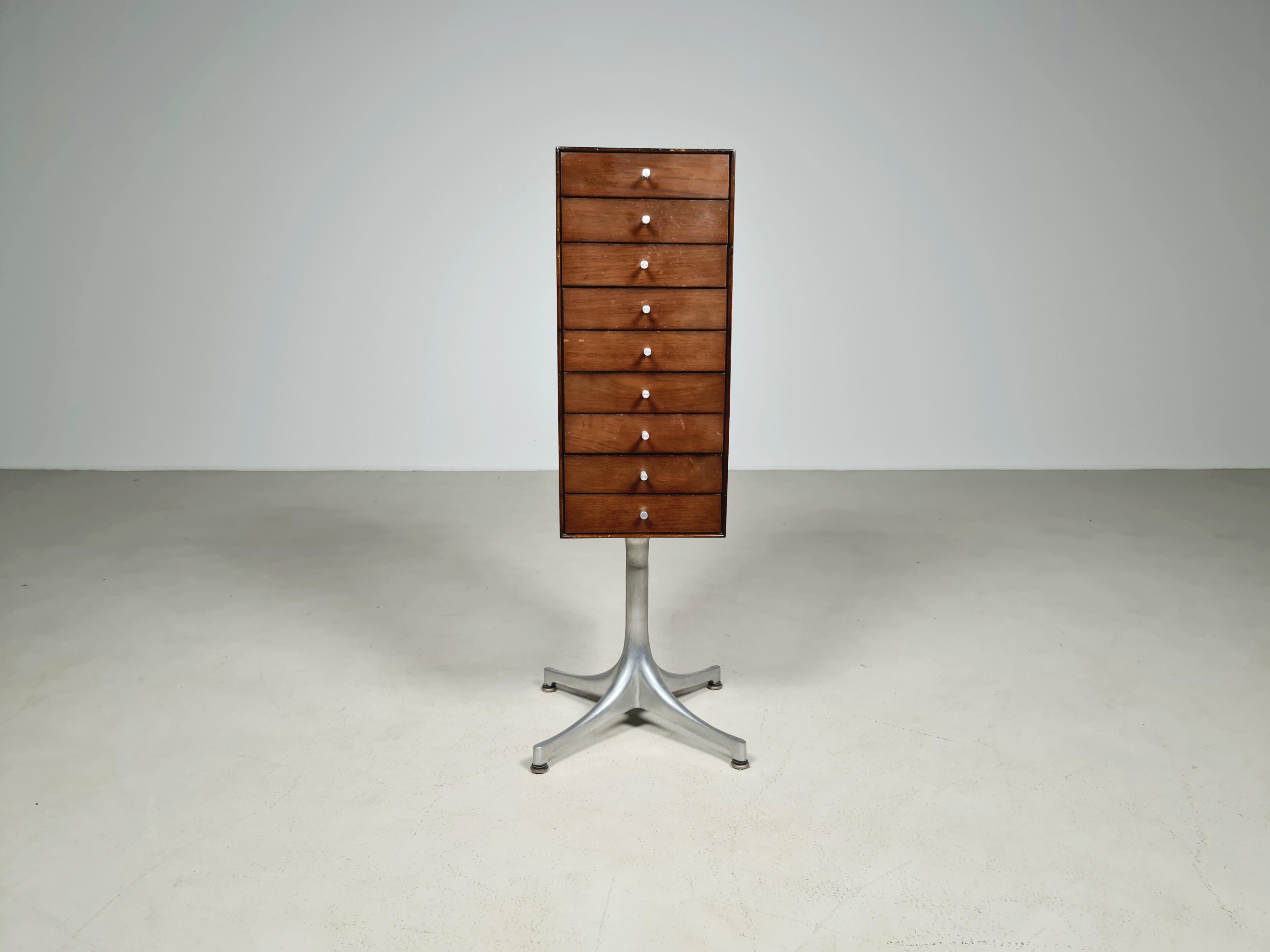 George Nelson vertical chest of drawers/jewelry cabinet for Herman Miller model 5517.
The walnut wood miniature chest, inspired by Japanese design, provides lots of wonderful spaces to keep little things. Made with hand-fitted drawers, Cast