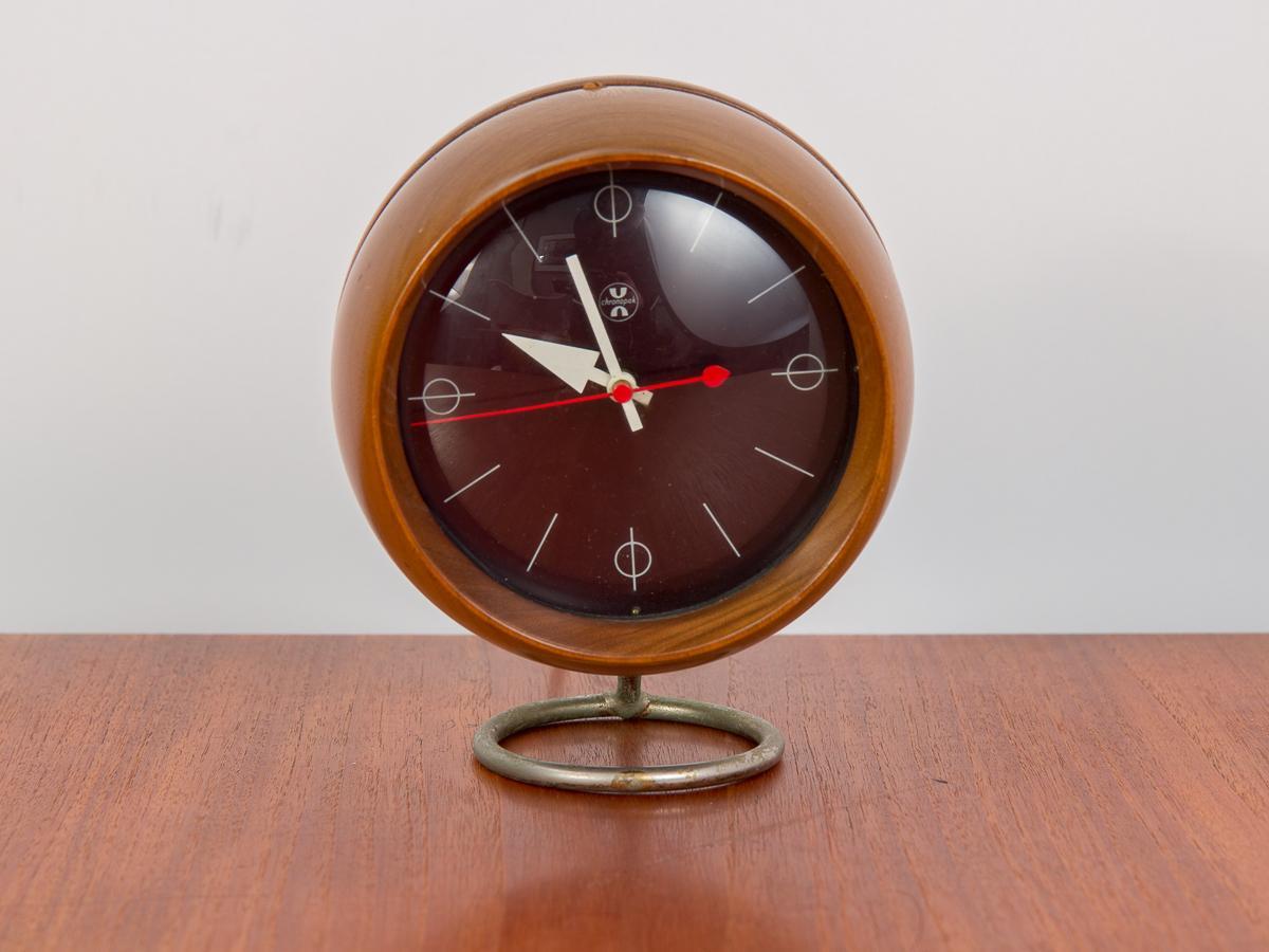 Scarce Chronopak table clock, designed by George Nelson for Howard Miller. Spherical body floats on chrome base. Pretty walnut wood selection has an attractive patina. A poised and sculptural tabletop companion to add that touch of 1950s Elan to