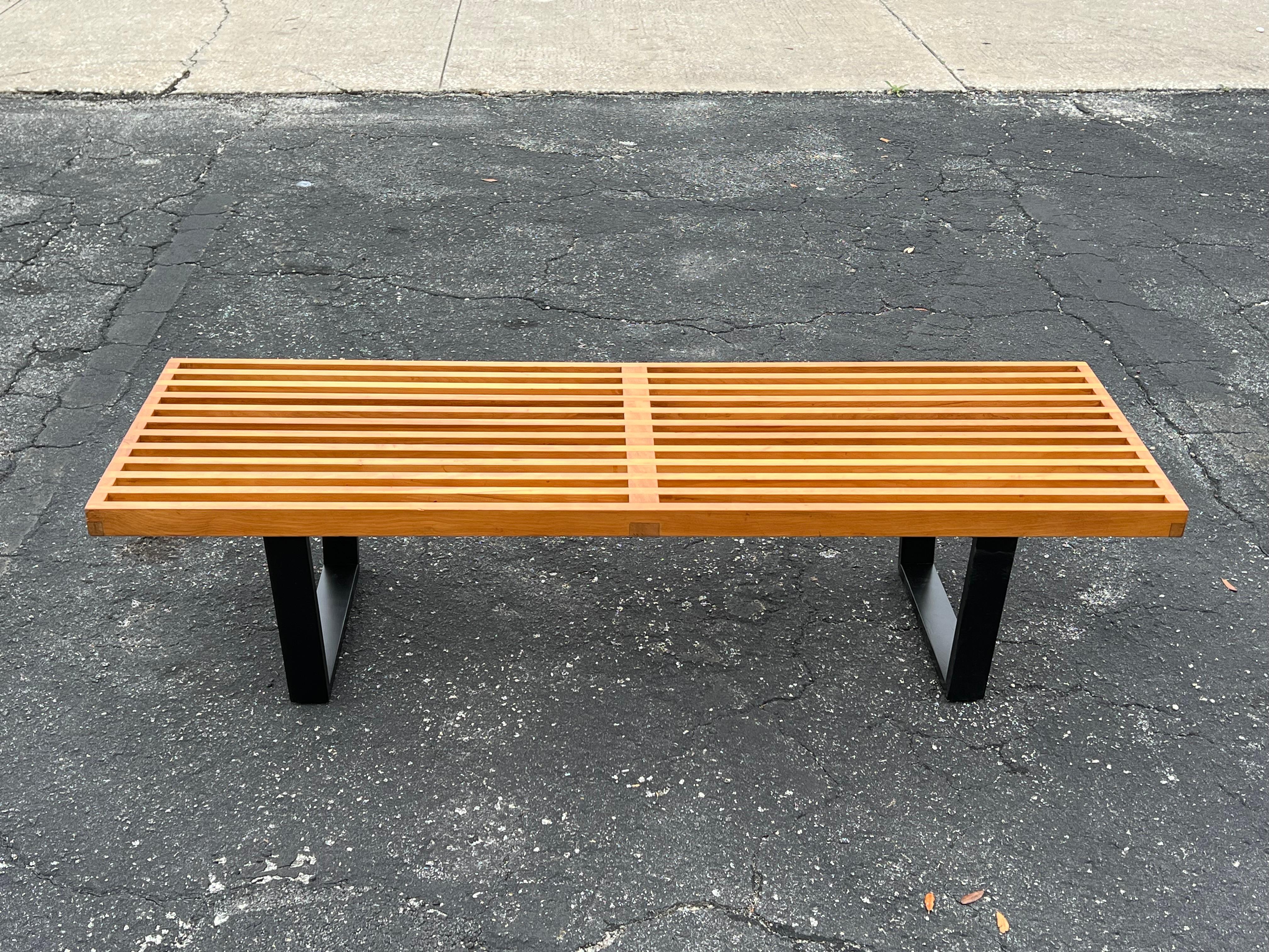 A classic, original 1950's vintage George Nelson for Herman Miller slat bench. Natural finish with warm patina and ebonized legs.  This is a hard to find original, retaining its foil label. The length is 56.5