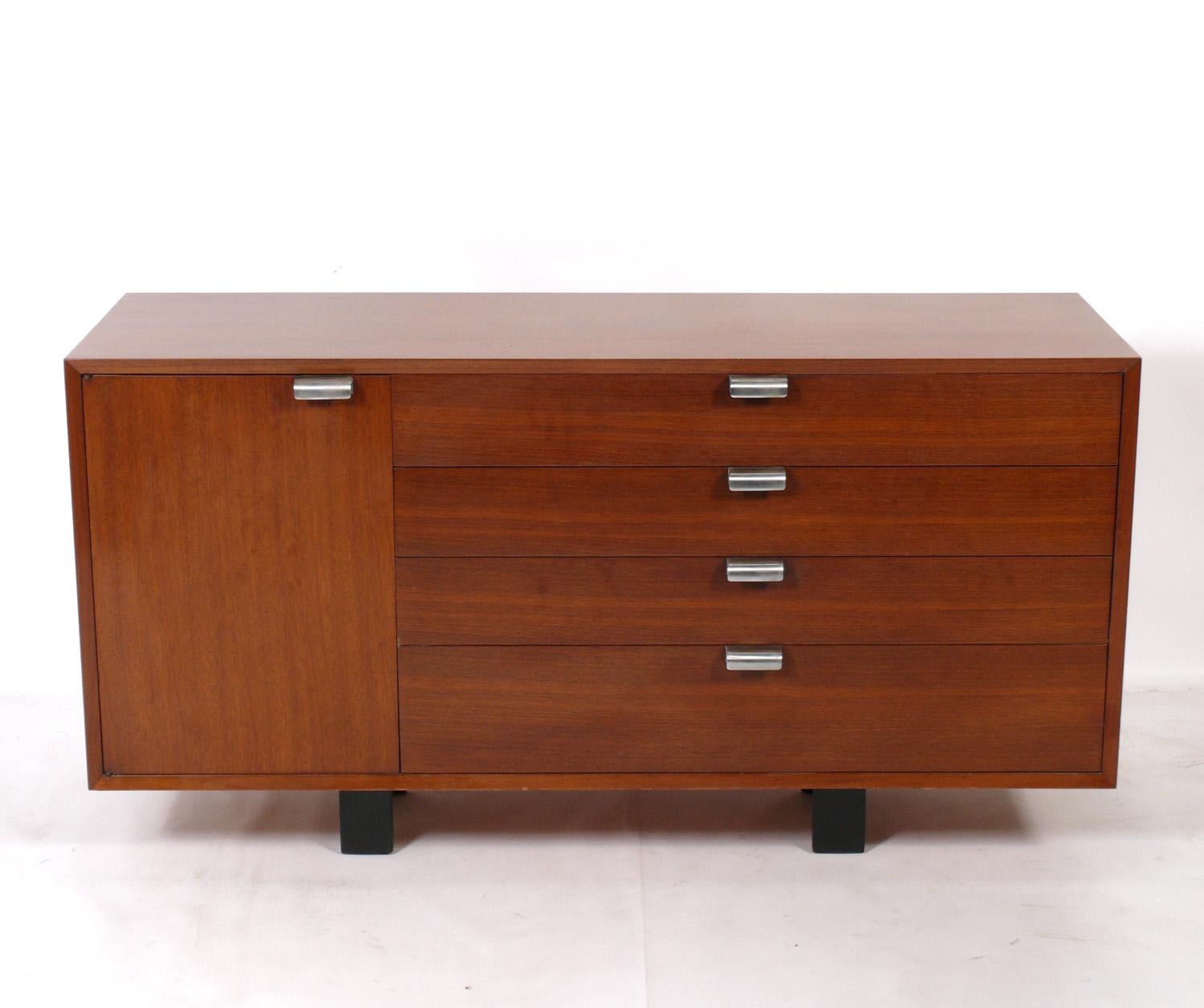 Clean lined Mid-Century Modern credenza or chest, designed by George Nelson for Herman Miller, American. circa 1950s. This piece is a versatile size and can be used as a credenza, bar, entertainment center, or cabinet in a living area, or or as a