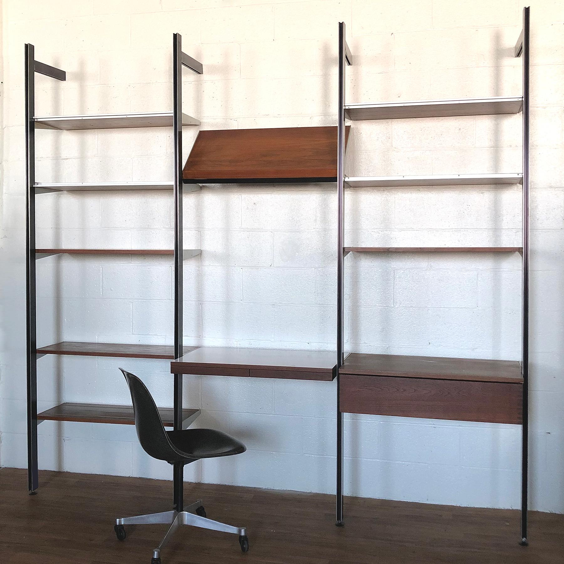 This CSS shelving unit is an excellent example. The beautiful design is comprised of four tension-mounted uprights which support nine teak shelves, a angled magazine shelf, a desktop with two pencil drawers, and a storage drawer with dovetailed