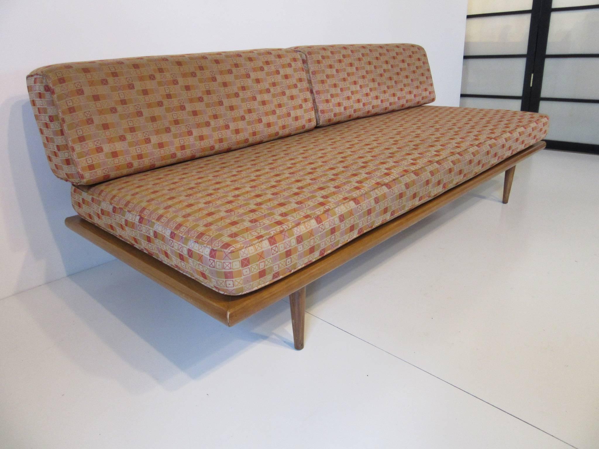 A natural birch wood framed Nelson daybed model # 5088 with back bracket, conical legs and upholstered in Ray and Charles Eames designed fabric . Retains the manufactures tag to the bottom frame by the Herman Miller Furniture company. Includes the