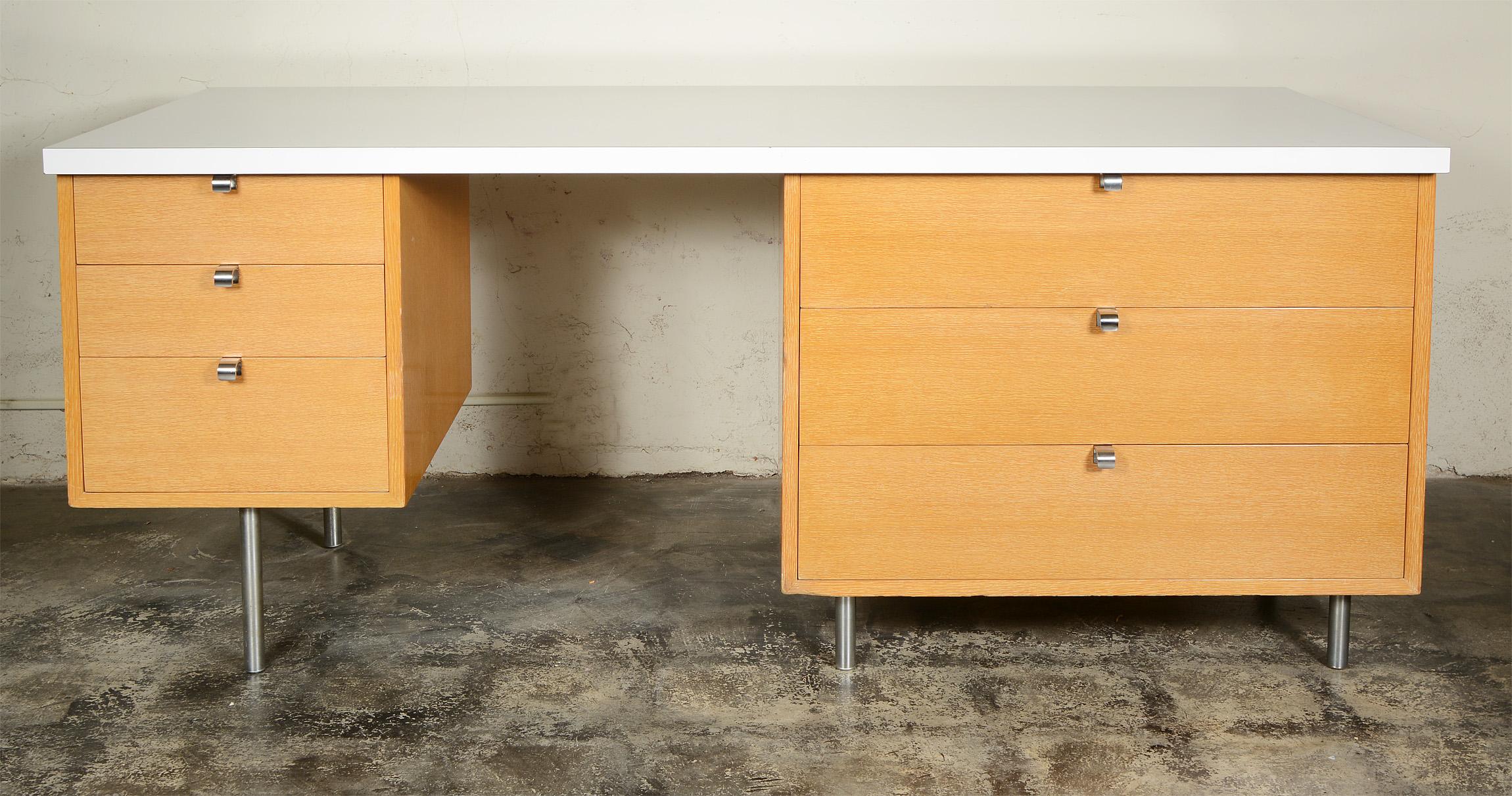 Double pedestal desk by Herman Miller. This desk was probably a custom order. There are three wide drawers and three small drawers. The top small drawer has a sliding pencil tray. The top drawer on the right side is divided. This is the comb grain