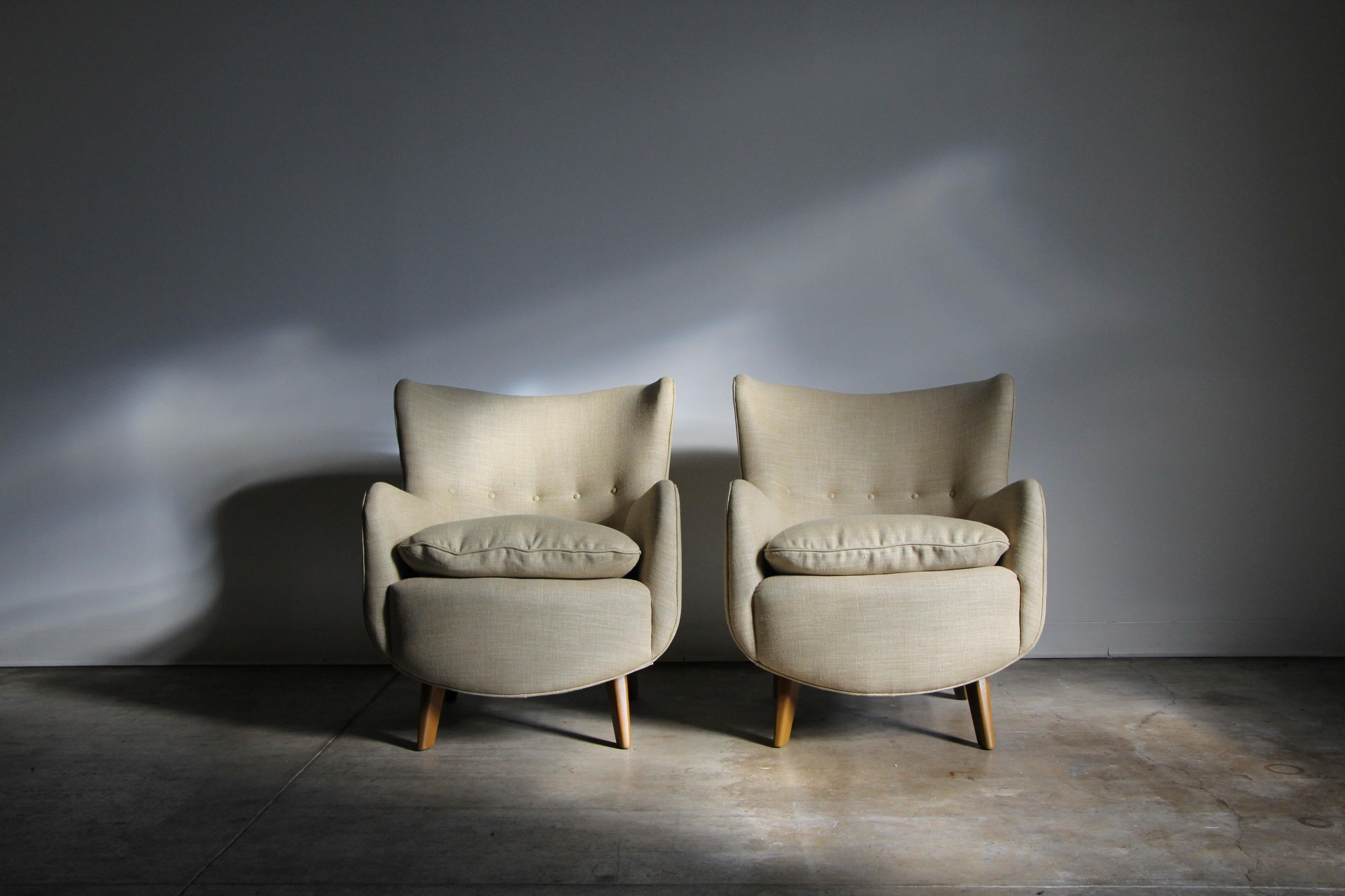 A stunning and exceptionally uncommon pair of George Nelson model '4688' wingback lounge chairs designed for Herman Miller in the 1940s. These petite lounge chairs embody understated elegance, with flowing lines, curved, hugging backs, and flared,