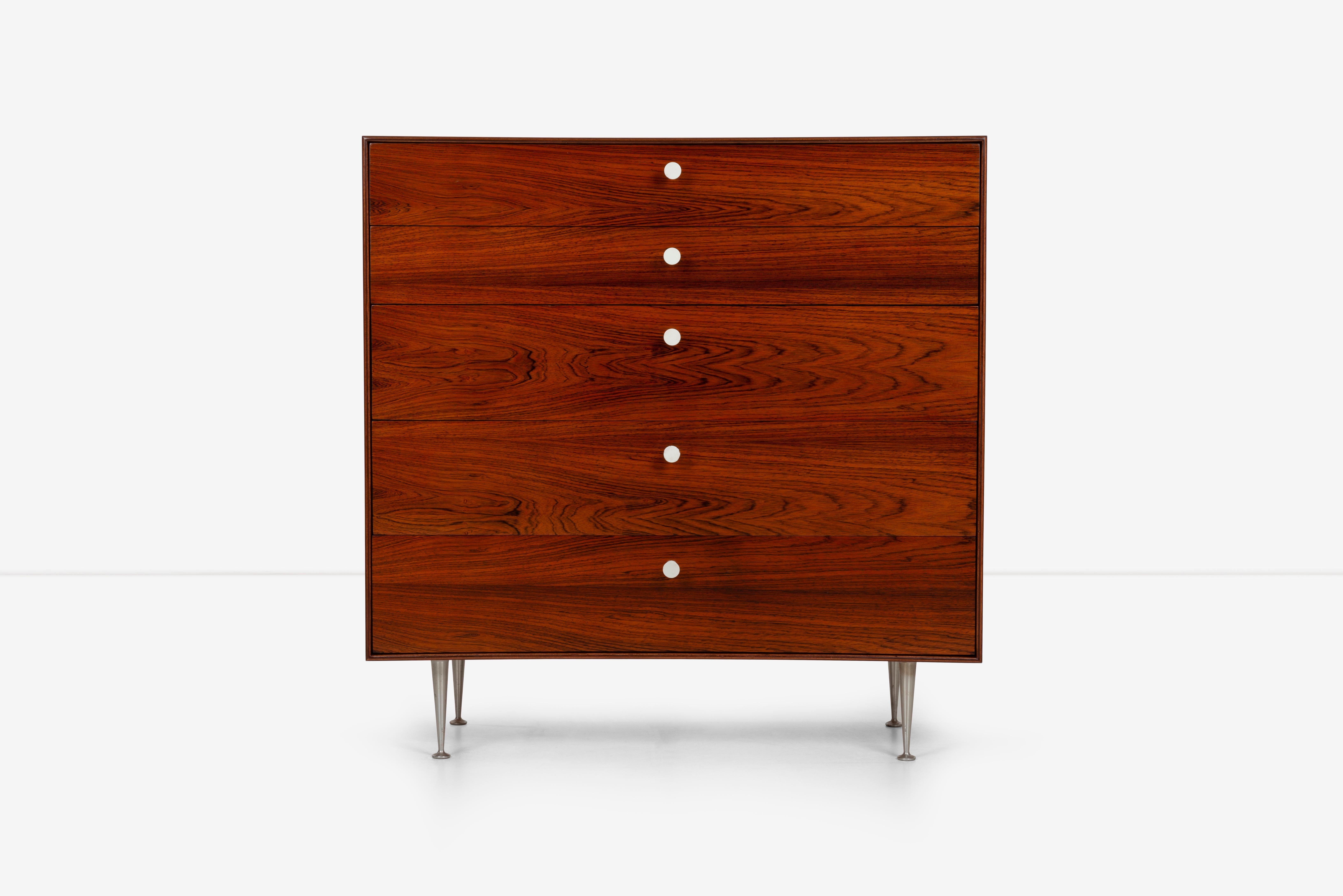 George Nelson five drawer thin edge rosewood dresser, dynamic rich rosewood graining, features five drawers with porcelain pulls and aluminum tapered legs. 
Foil label inside drawer (George Nelson for Herman Miller).