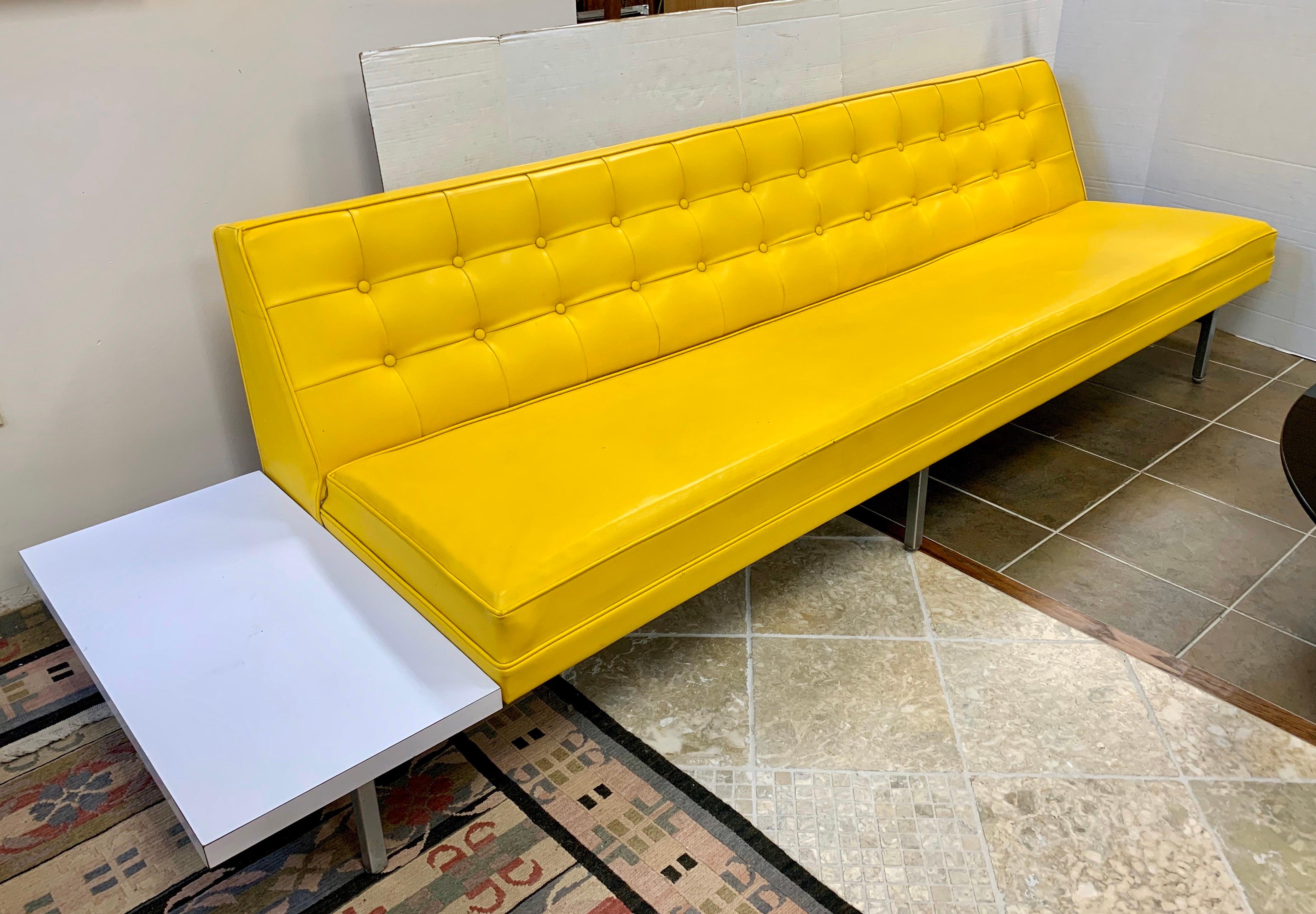 Elegant and iconic midcentury signed living room set designed by George Nelson for Herman Miller.
It features original banana yellow vinyl upholstery which is ultra rare and coveted.
The frame is made of chrome steel. Each of the two modular