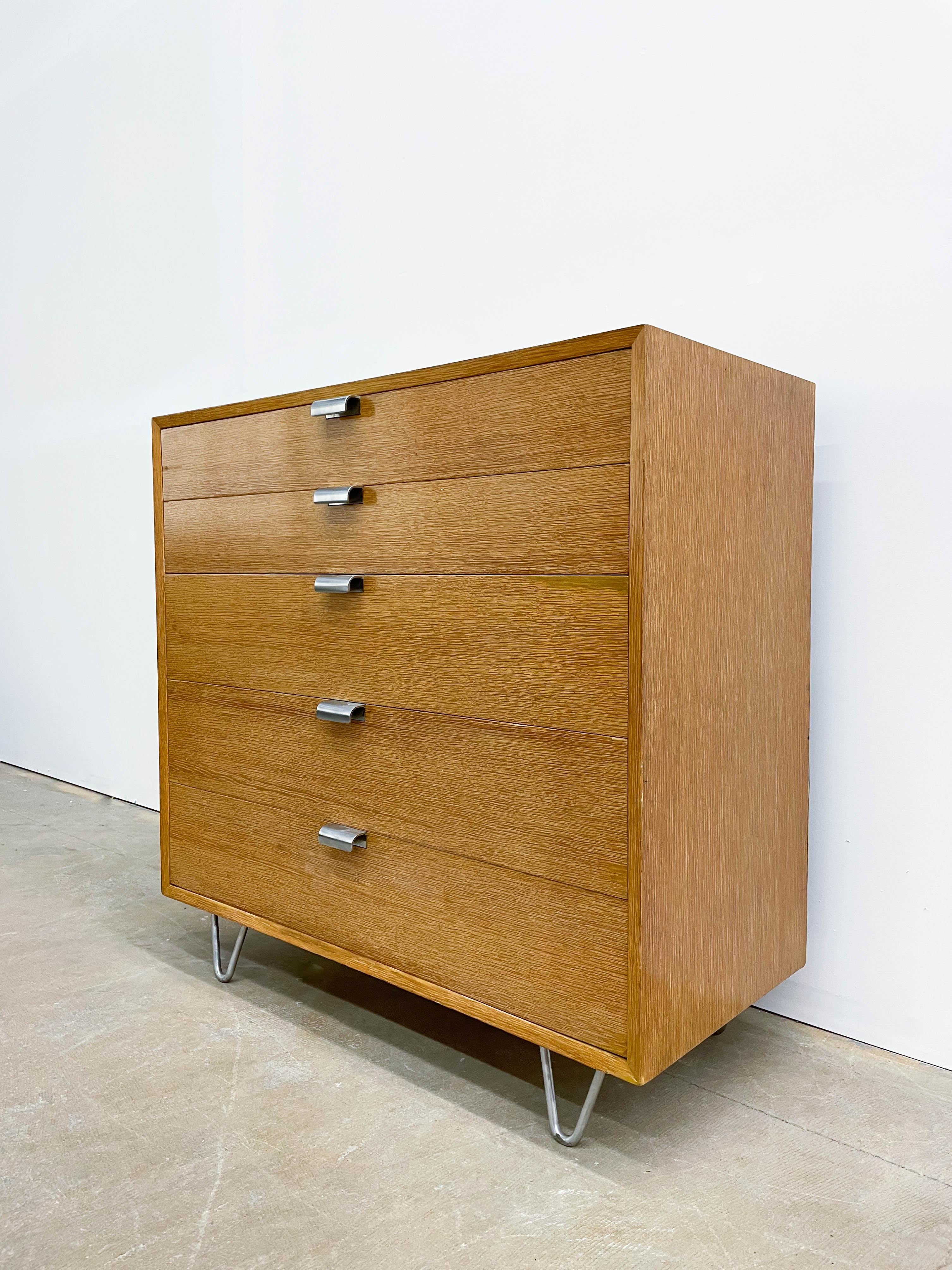 This iconic dresser comes from George Nelson's first collection for Herman Miller in 1948. The impressive, tall dresser boasts chrome pulls and highly dought-after hairpin legs. The dresser is part of the first Basic Cabinet Series, now more