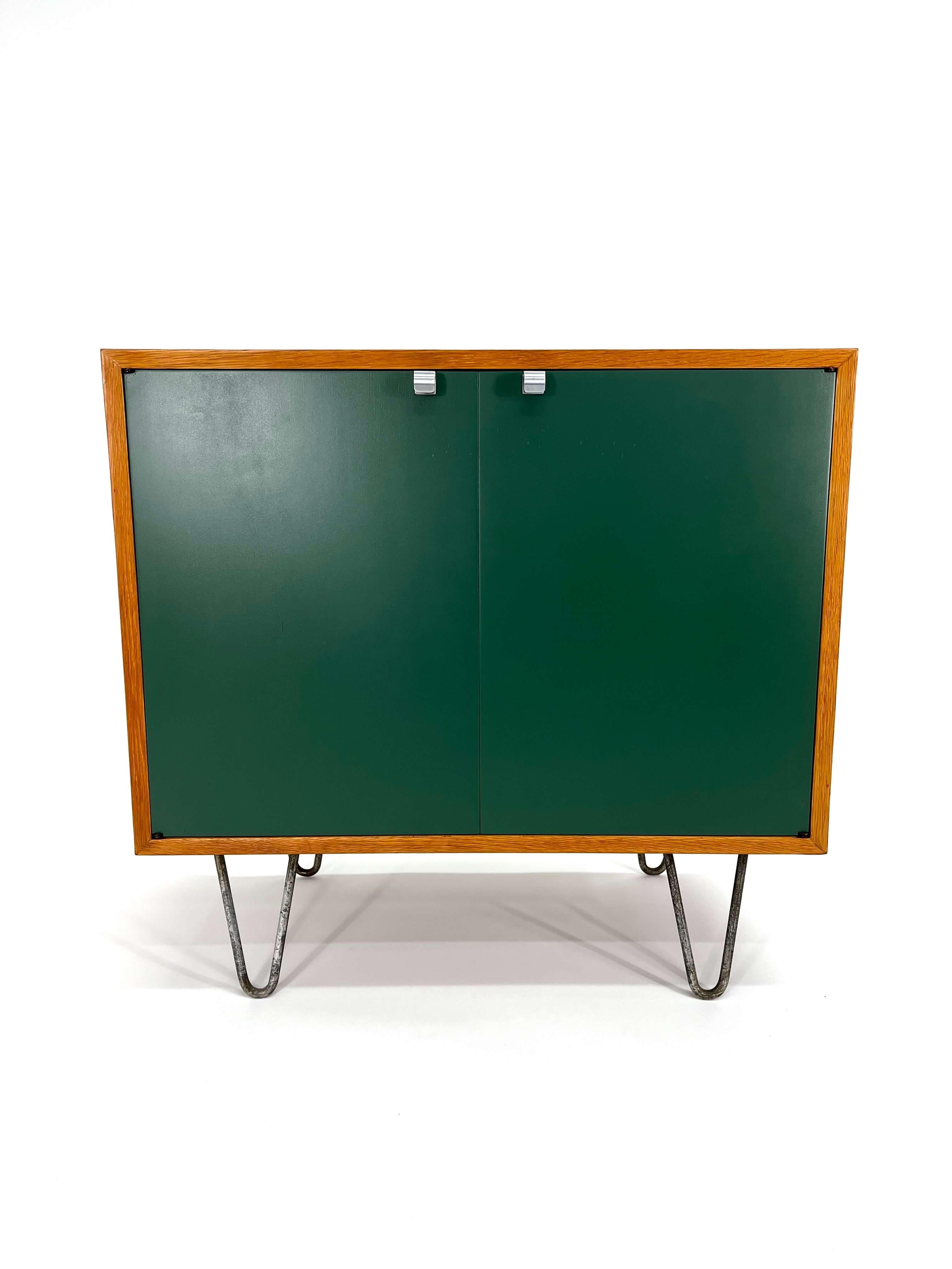 George Nelson for Herman Miller Green Front Two Door Cabinet model 4625, with 2 doors and single shelf designed in 1952.

George Nelson was an iconic designer who collaborated with Herman Miller to create some of the most innovative and sought-after