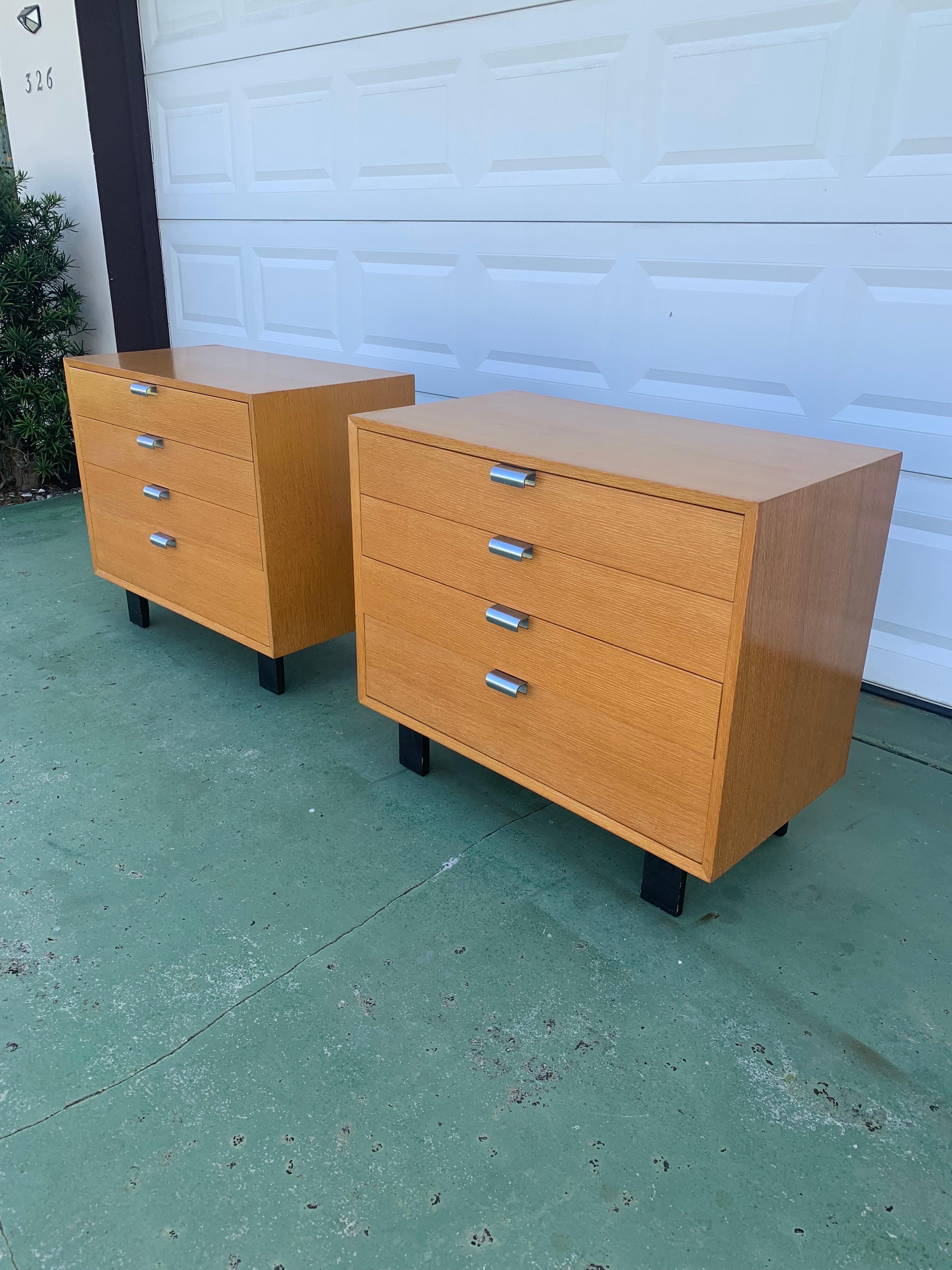 A beautiful pair of dressers designed by George Nelson for Herman Miller. Finished in a spectacular combed oak veneer. One of the most lively, beautiful, vibrant veneers we’ve ever seen.

Metal over hang pulls and the cases sit on thick sturdy black