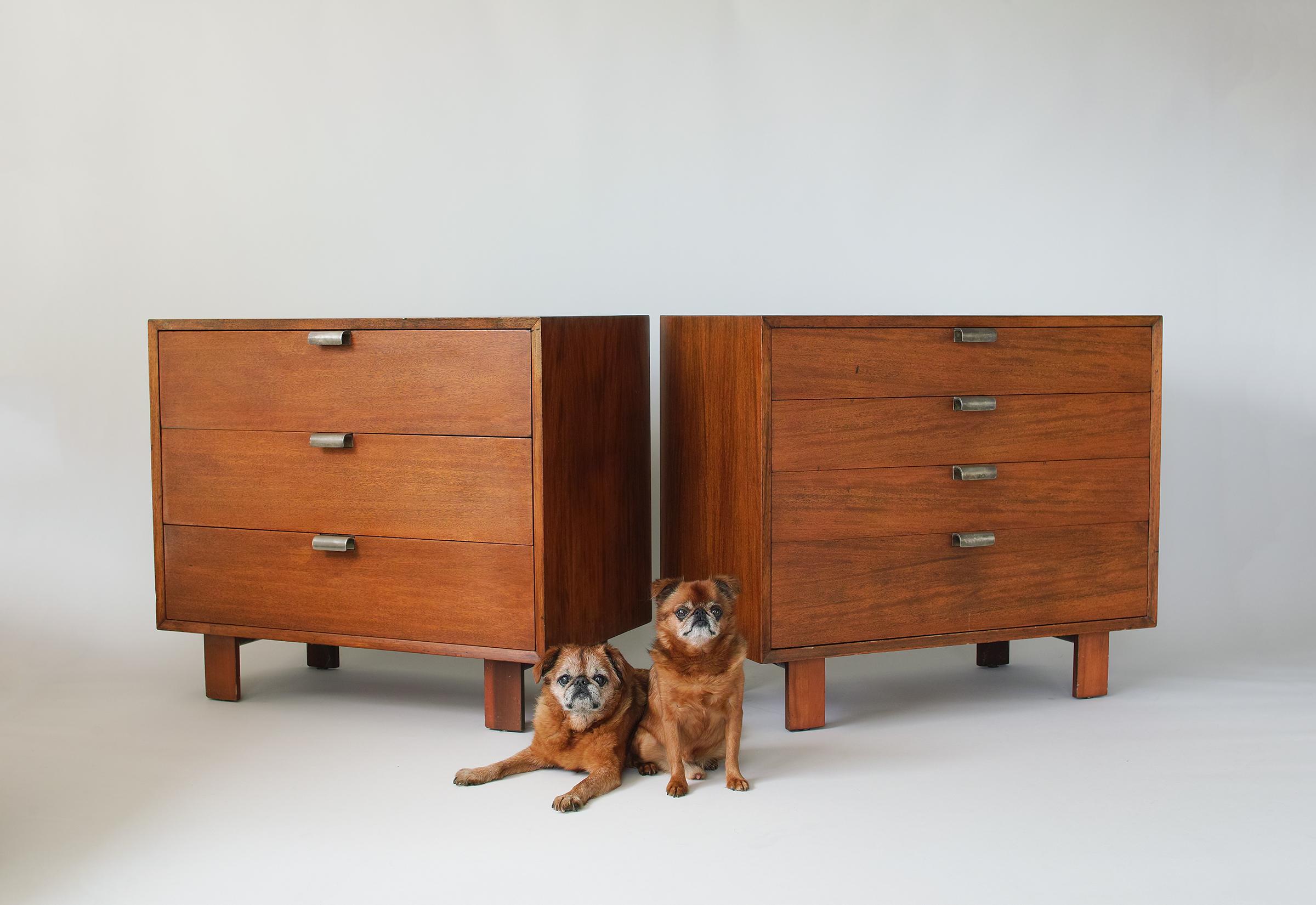 For your consideration is this handsome pair of George Nelson for Herman Miller chests of drawers featuring walnut cases with nice warm patina and original metal drawer pulls. The four drawer chest has interior dividers in both the top and bottom