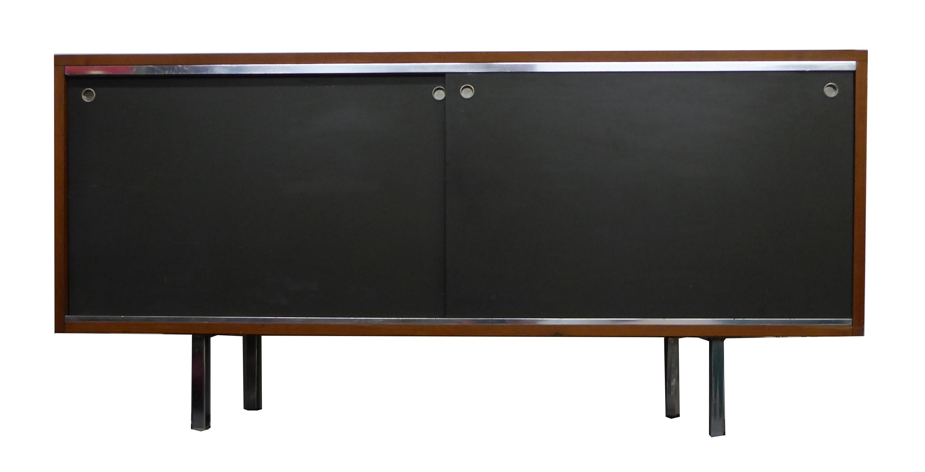 Handsome George Nelson credenza designed in 1952 for Herman Miller. Walnut, stainless steel
and black laminate.