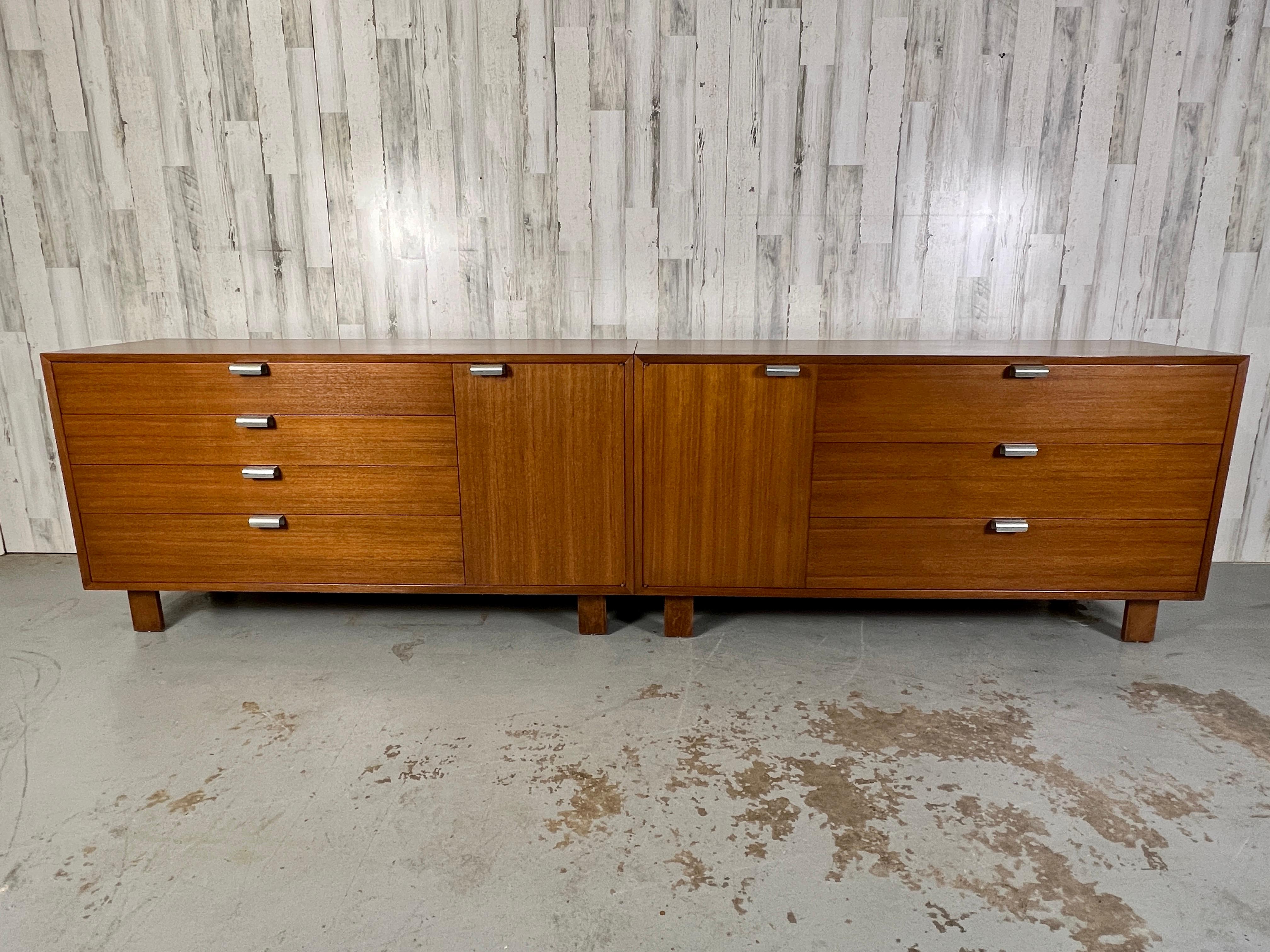 Two Mid-Century Modern credenza or dressers, designed by George Nelson for Herman Miller, American, circa 1950s.
Both cabinets are the same dimensions the one on the left has three drawers and the right on has four drawers. The cabinet door is the