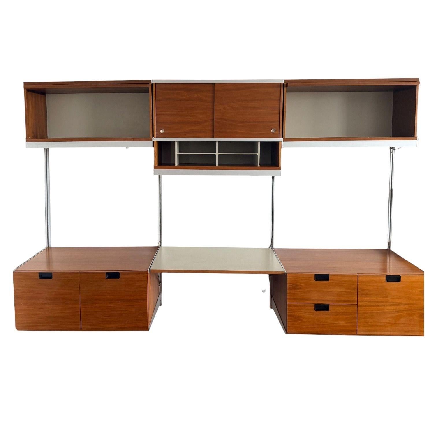 George Nelson for Herman Miller CSS Wall Unit, 1950’s.  Unit is Walnut and made in Zeeland, Michigan.
Measures 96” wide 19.5” deep 63” tall
2 Bottom drawers 17” tall 32” wide 19.5” deep
2 Top Cabinets 17” tall 32” wide 12.5” deep
Top Middle Cabinet