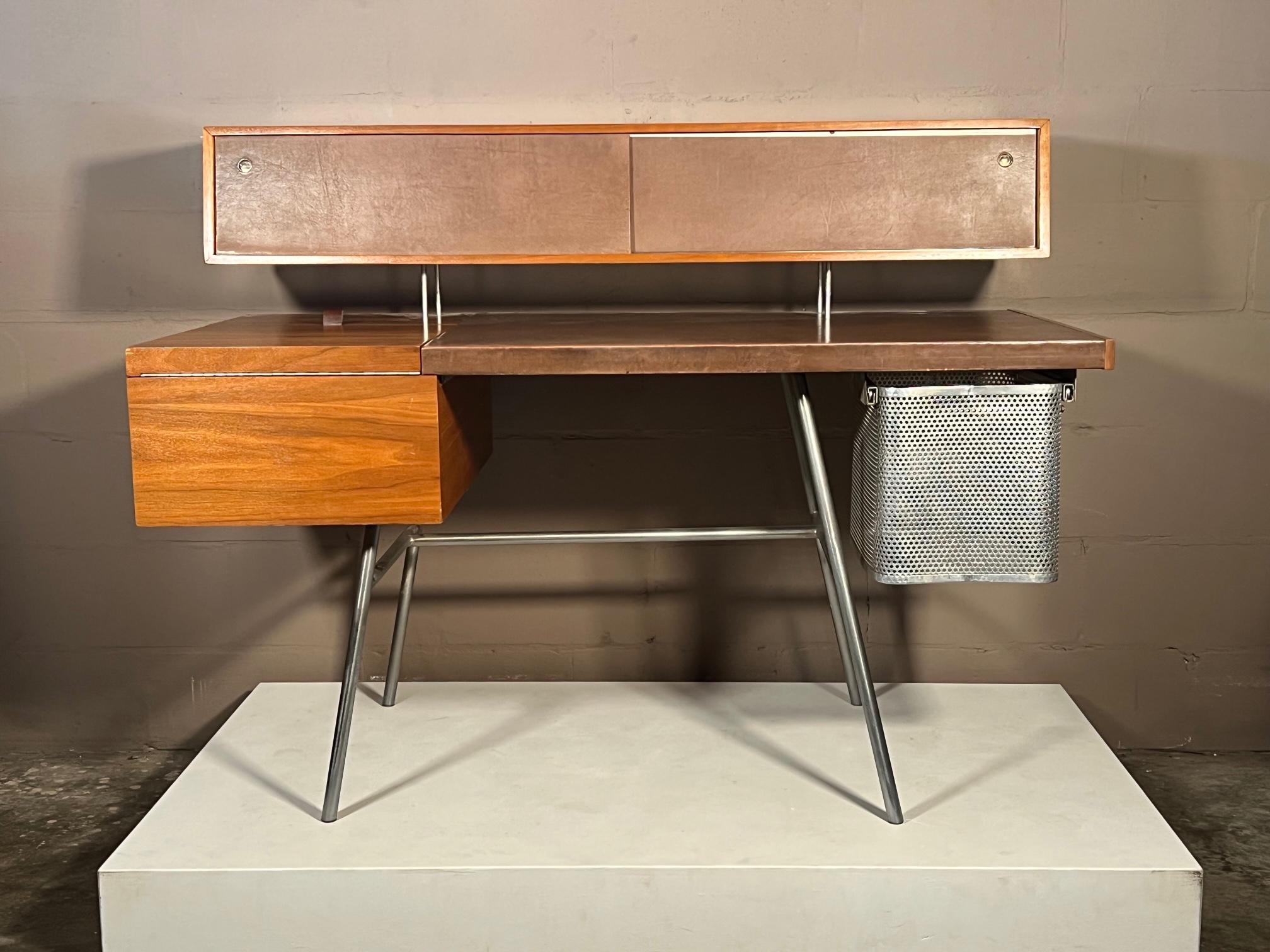 George Nelson for Herman Miller desk model # 4658, in walnut, steel and leather, ca' late 1940's. A Classic Postwar modernist desk made of walnut with steel legs and its original brown leather writing surface, showing a beautiful patina. The desk