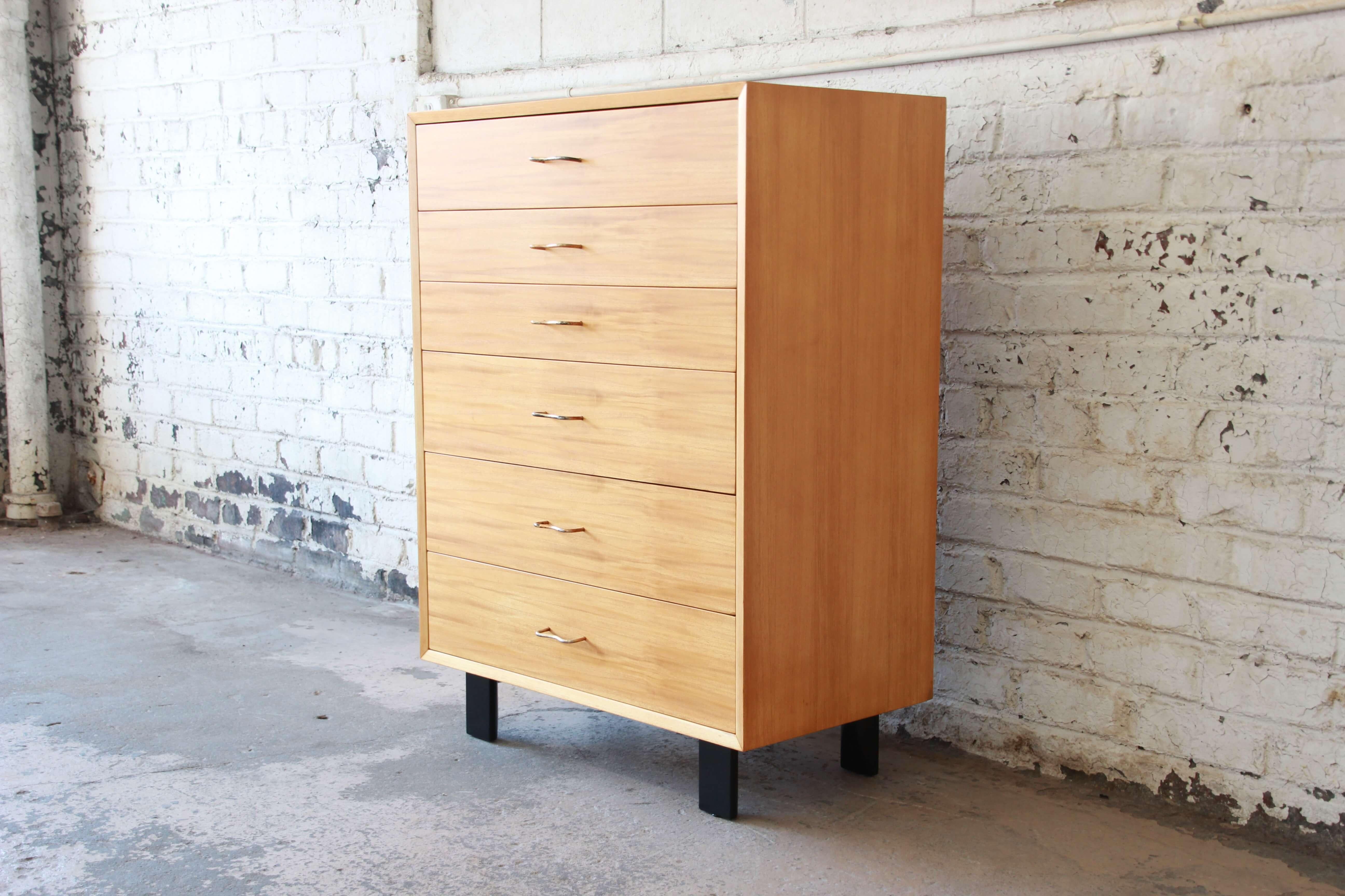 Offering a very nice newly restored George Nelson highboy dresser for Herman Miller. The dresser has six smooth sliding drawer offering varying sizes. The base of the chest has nice signature black legs often seen in Nelson's work. The original