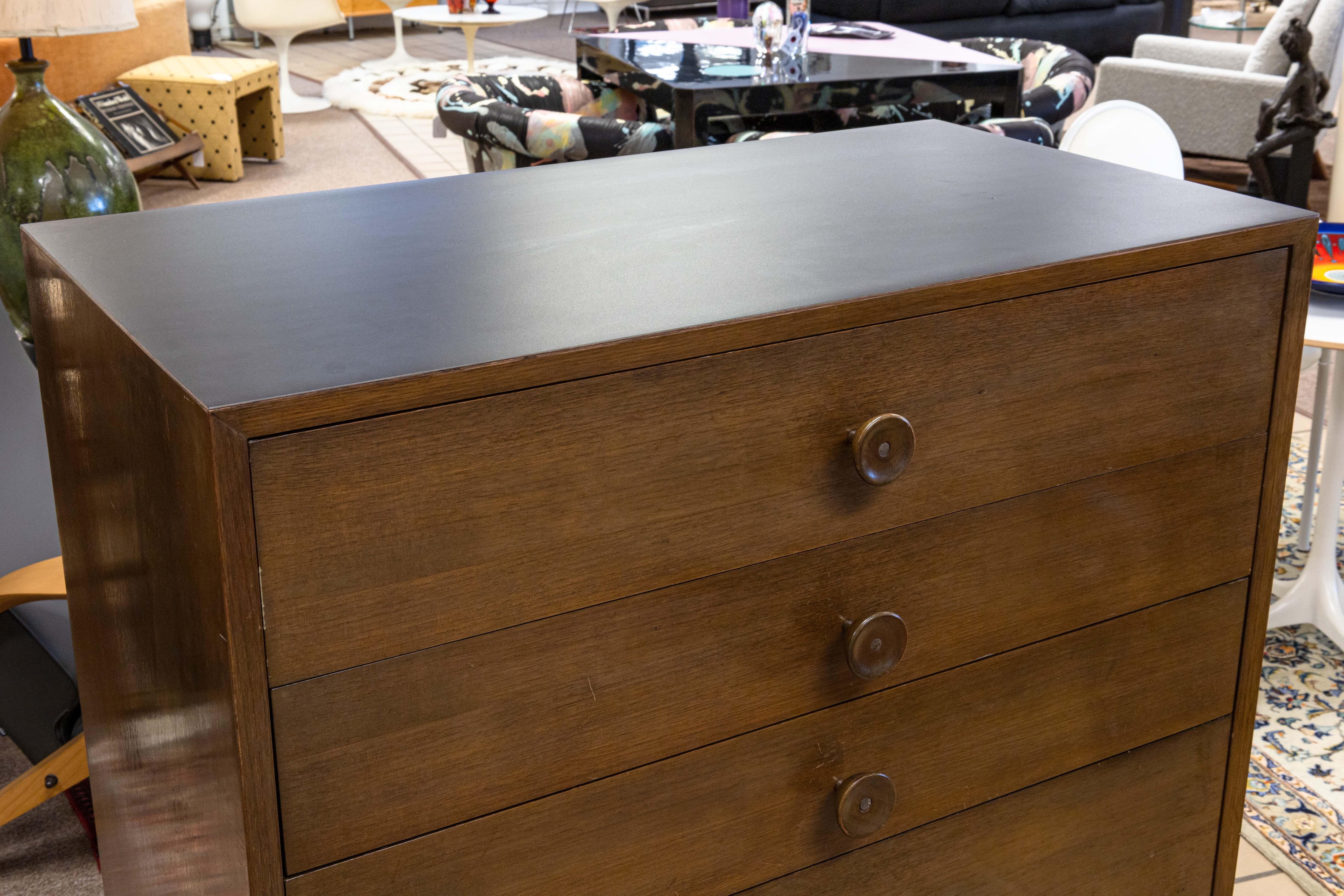 A George Nelson for Herman Miller hi-boy dresser. An incredible chest of drawers with simply but stunning mid century styling. This piece features a full walnut wood body construction. This piece has 6 sliding drawers, with a variety of sizes, and