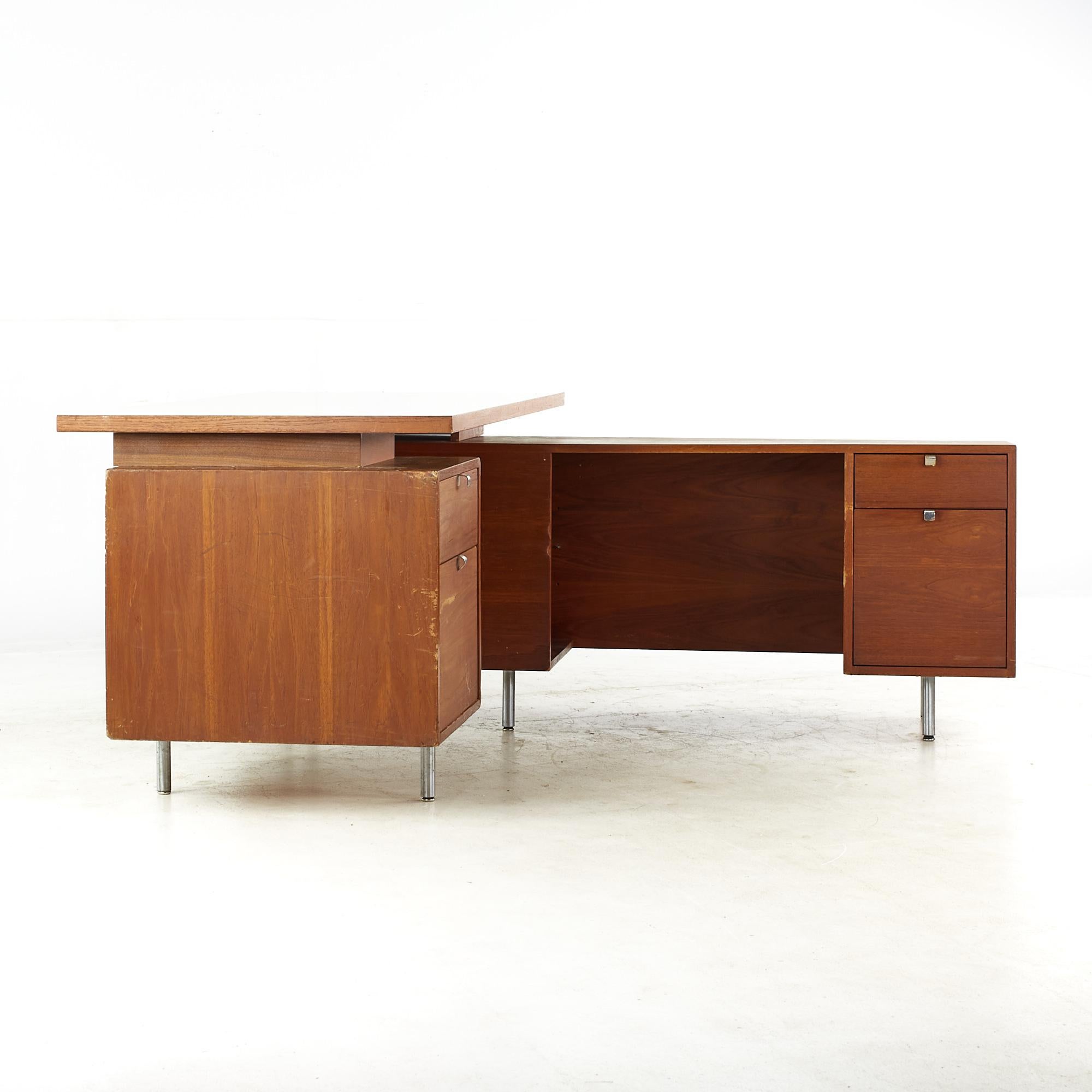 George Nelson for Herman Miller Mid Century Walnut Corner Executive Desk

This desk measures: 60 wide x 30 deep x 29.75 high, with a chair clearance of 25 inches
The return measures: 60 wide x 41.5 deep x 25.75 inches high

All pieces of furniture