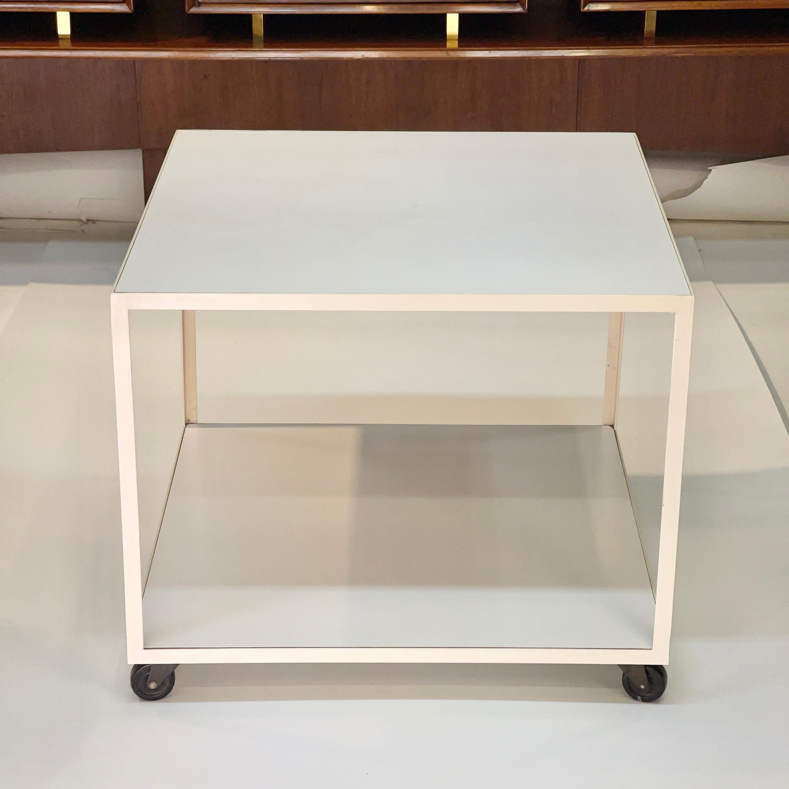 White enameled steel frame and white laminate rolling cart designed in 1951 by George Nelson for Herman Miller. Also referred to as an Angle Iron table. Original metal label present underneath top tier.
Per the George Nelson Foundation this table