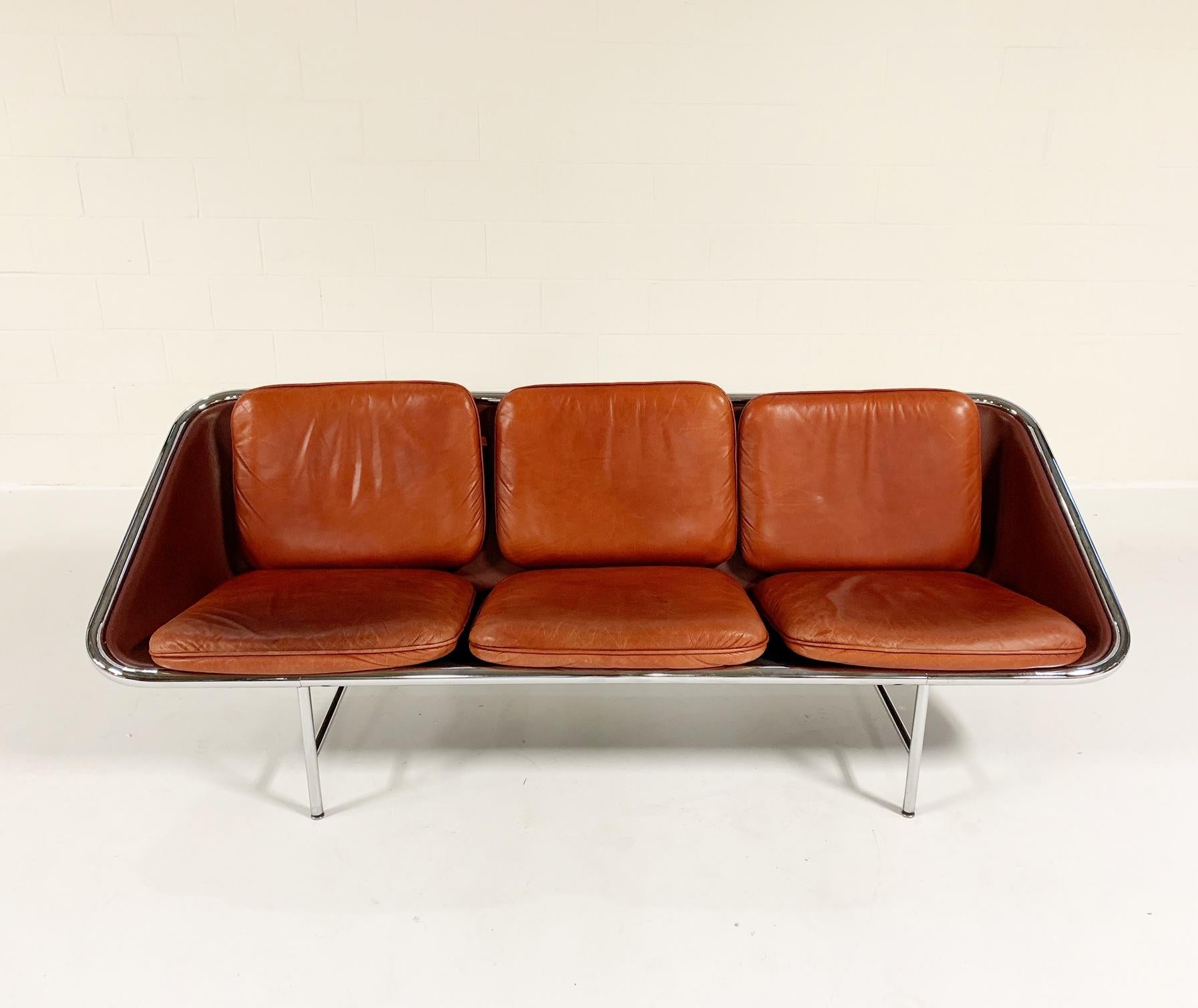 An exceptional piece of midcentury design. We fell in love with the exquisite lines of this Model 6832 leather sling sofa by George Nelson for Herman Miller. The chestnut leather is in great shape, showing a beautiful patina. Choose a few pillows