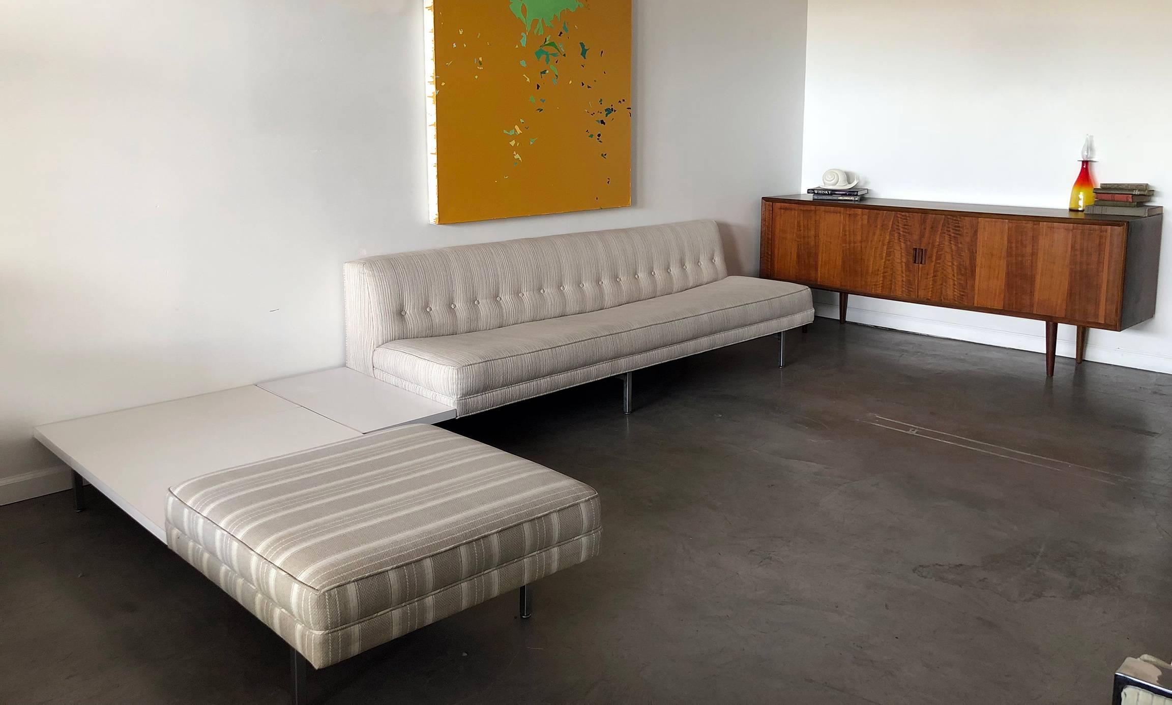 A stunning, iconic piece of Mid-Century Modern design, a George Nelson for Herman Miller sectional sofa! The sofa is in good vintage condition with neutral fabric and attached side tables with white laminate tops.

The set is two separate pieces