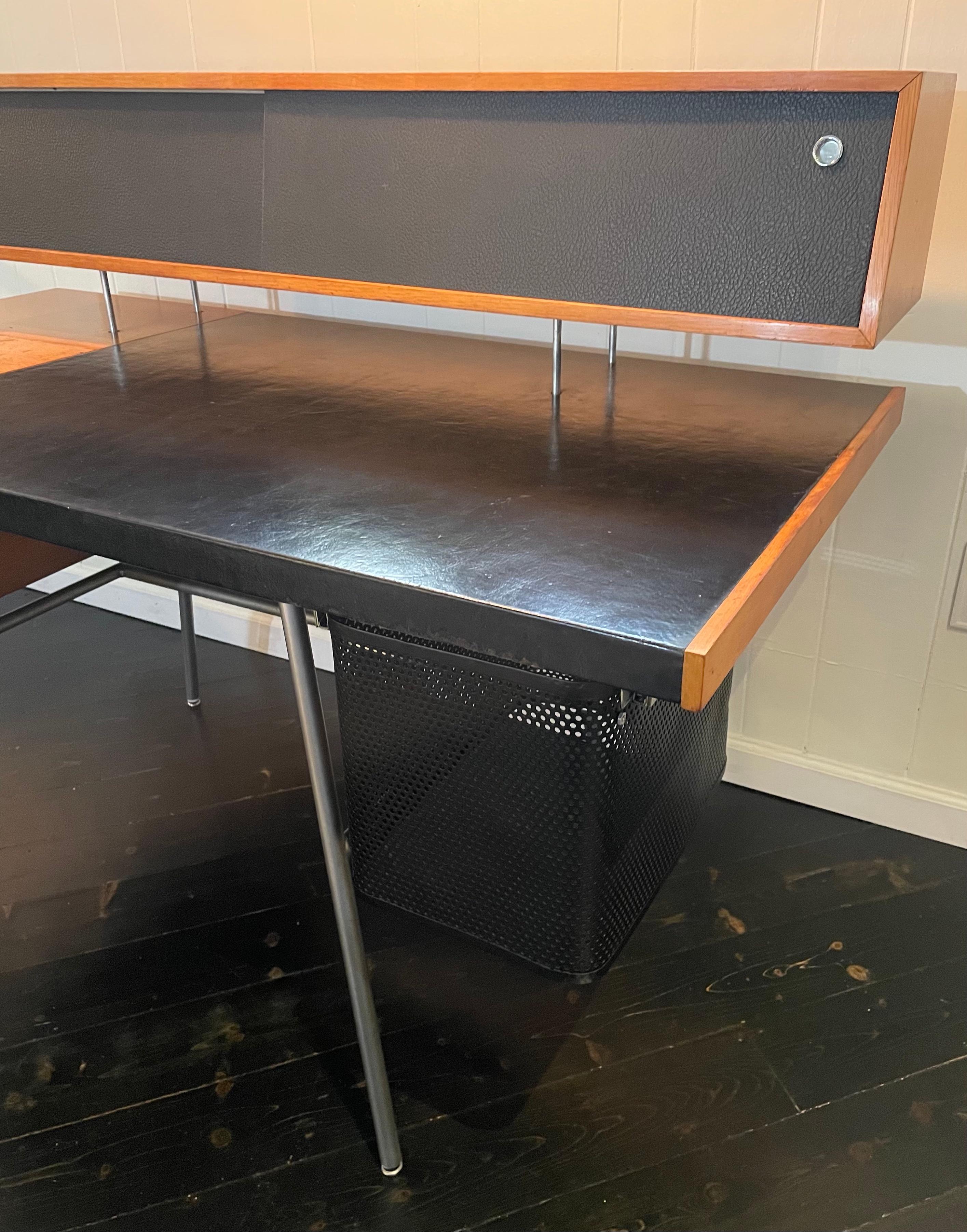 Rare black leather top desk in original condition, acquired from NYC architect's estate. This color combination is part of the permanent collection at the Cooper Hewitt Museum in New York City.

Designed by George Nelson and Associates and