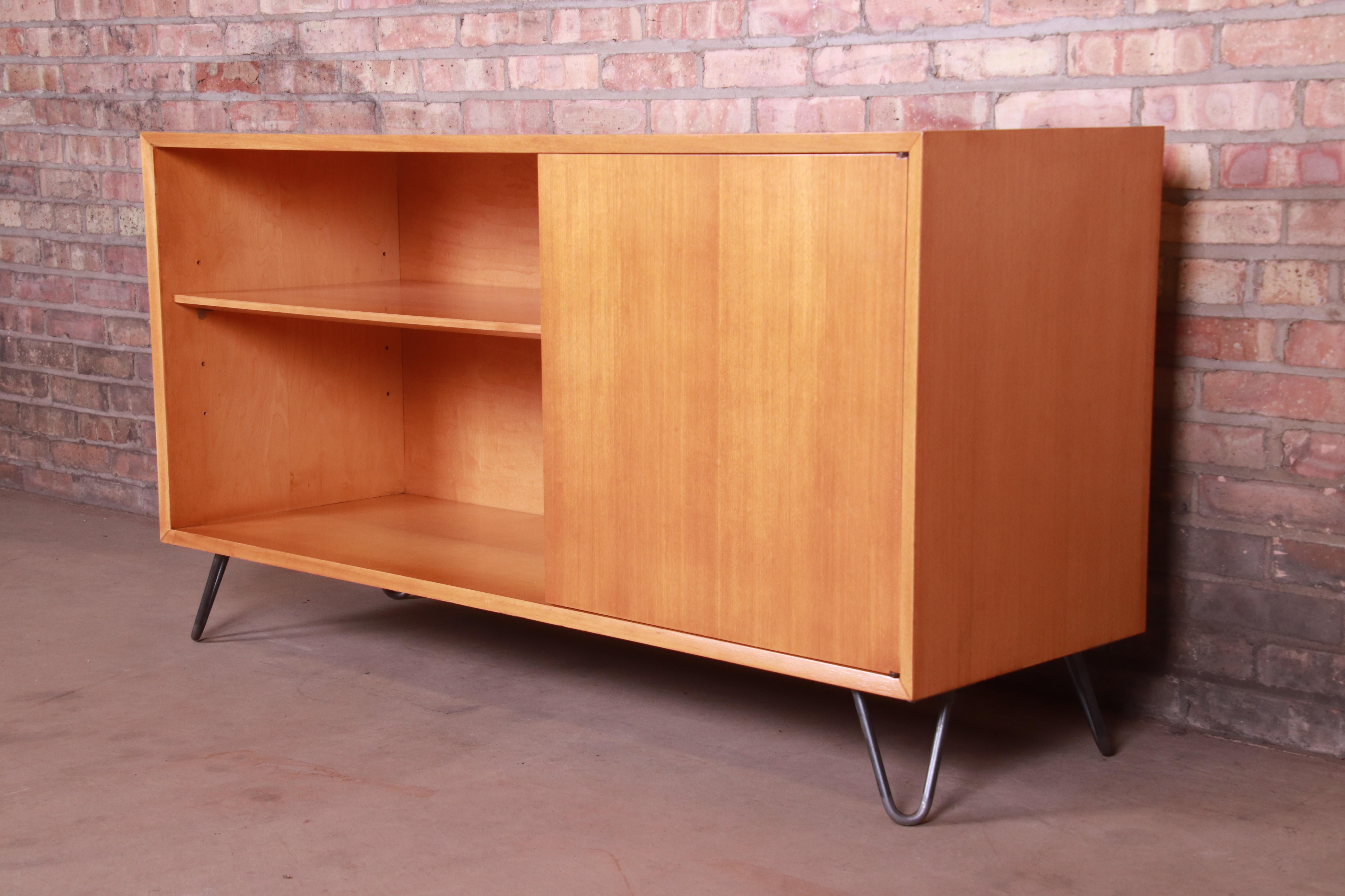 An exceptional Mid-Century Modern credenza or bookcase

By George Nelson for Herman Miller,

USA, 1950s

Primavera wood case, on steel hairpin legs.

Measures: 56.25