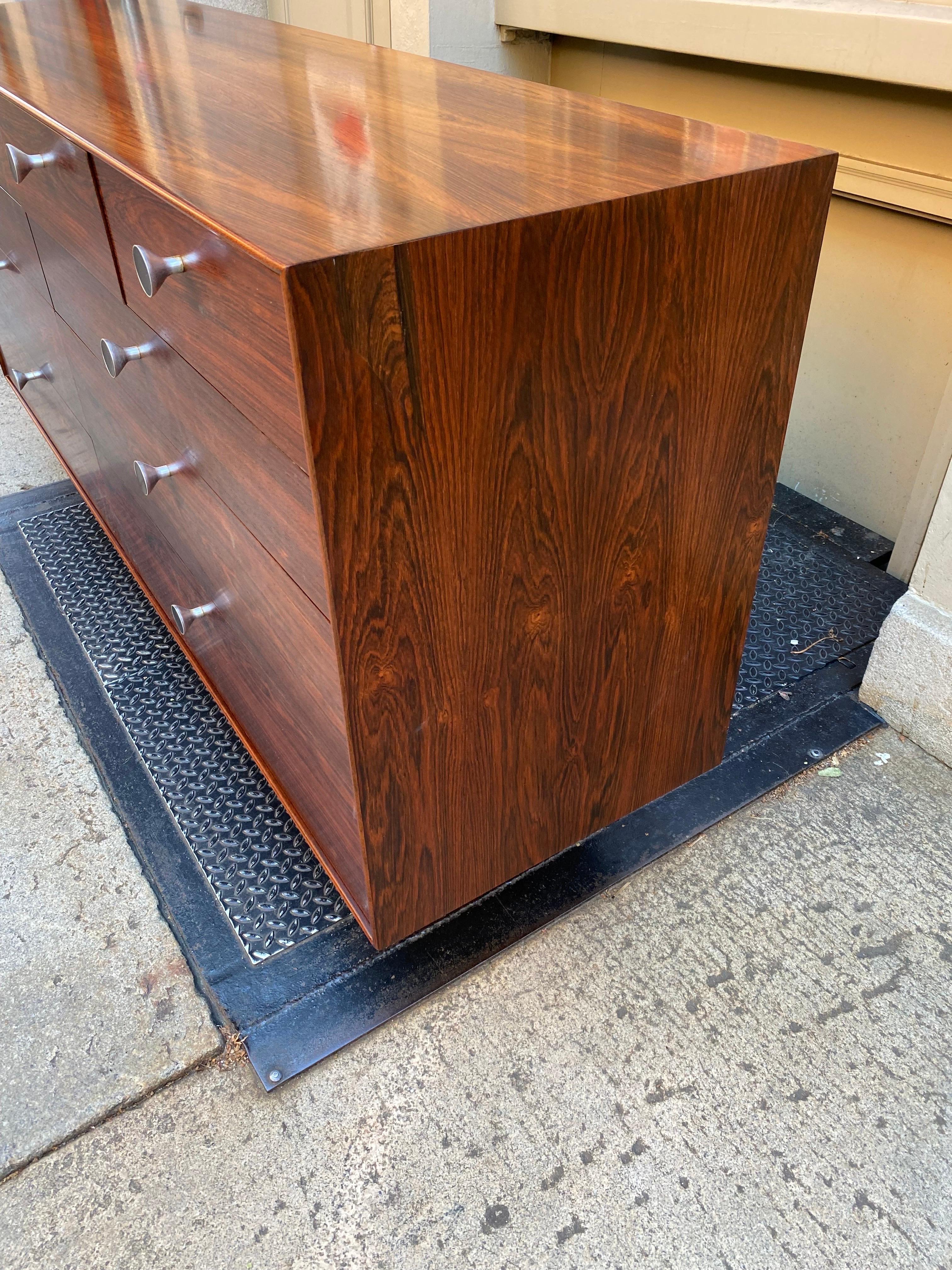 George Nelson rosewood thin-edge 10 drawer dresser. Beautiful piece with tons of storage! Aluminum Feet and knobs with black inner circle. Dresser includes original hang tag! Label inside drawer. Thin-Edge pieces are probably one of his most sought