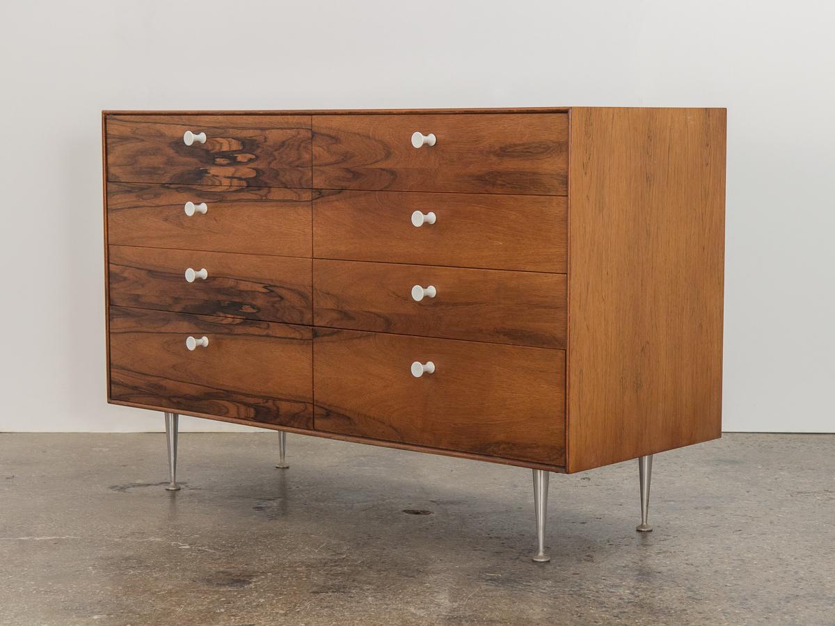 Spectacular rosewood Thin Edge collection model 5221 eight-drawer dresser, designed by George Nelson for Herman Miller. Drawer fronts show off gorgeous figured rosewood selection, finished with the designer’s signature porcelain knobs. Named for its